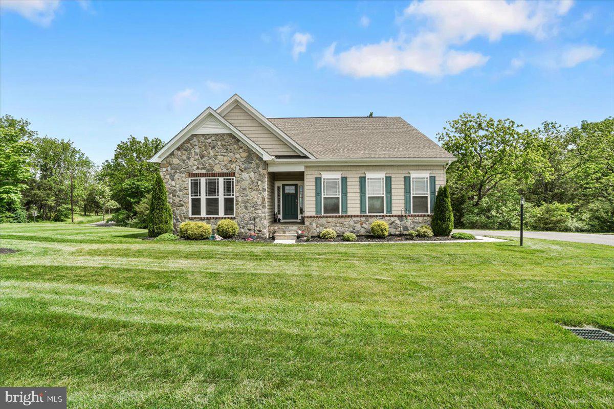 Charming Raised Rancher in The Links of Gettysburg – Bradford Model by Gemcraft Homes
Situated on a prime corner lot, with a flagstone entry way to this beautifully maintained 3-bedroom, 2-bath Raised Rancher. This home offers exceptional privacy and modern comfort in the sought-after Links of Gettysburg community. 3312 total square footage in the home
Step inside to discover rich Hickory hardwood flooring throughout and a spacious open floor plan, enhanced by a 4-foot bump-out and soaring 9-foot ceilings. The great room features a stunning stone-faced gas fireplace—perfect for cozy evenings—and flows seamlessly into the dining area and kitchen. The well-appointed kitchen boasts granite countertops, soft-close drawers and cabinets, pull out shelving and a custom wood backsplash,. All stainless steel appliances convey.
The primary suite is a true retreat, offering dual sinks, ceramic flooring, and a beautifully tiled walk-in shower. Ceiling fans are installed in every bedroom for year-round comfort. Step out onto your private 10 x 14 Trex deck, where you’ll enjoy peaceful views of the wooded area behind the home—providing rare privacy within the community.
An unfinished walk-out basement adds valuable potential—ready to be transformed into a home gym, entertainment space, or additional living area to fit your lifestyle.
Additional highlights include recessed lighting, a 2-car garage, and professional landscaping.
Community Amenities Include:
Golf course with optional membership
Clubhouse with swimming pool and jacuzzi
Tennis and pickleball courts
Located just 10 minutes from historic downtown Gettysburg and the Maryland state line, this home offers the perfect blend of convenience, comfort, and resort-style living.