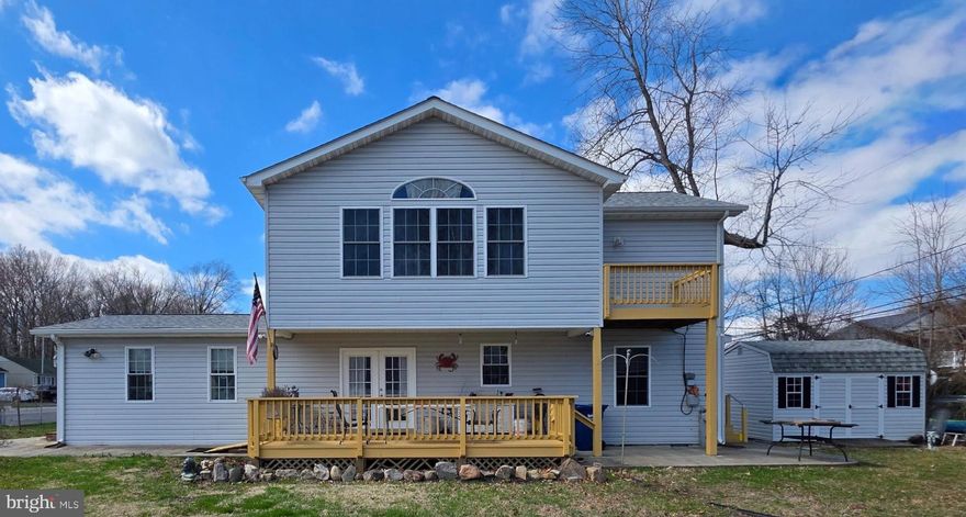 "CHESAPEAKE BAY LIVING"  Beautiful & Very Cozy Home located only 4 Blocks from the Chesapeake Bay!!!! You can live here year round or make this your Amazing Vacation Beach Home * This Beautiful Home was totally Renovated all the way down to the studa & added 2nd story in 2009 **  Enjoy an Amazing Walk down the Boardwalk while you take in the Stunning View of the Glorious Chesapeake Bay!!!  There are a lot of Local Shops & Restaurants to enjoy that you can walk to *** This Beautiful Home Features:  A Very Spacious Living Room with lots of Windows & Beautiful Hardwood Floors * Gorgeous Kitchen with Beautiful White Cabinets, Granite, Breakfast Bar, Stainless Appliances, Gas Oven & Dura Ceramic Flooring * Main Level Bedroom with a Huge Walk-in Closet  & Hardwood Flooring, also has a private entrance door & Full Bath* Powder Room * Utility Room *** The Upper Level Features:   Huge Primary Bedroom with Vaulted Ceiling, Walk-in Closet, with a French Door to the Balcony * Large Primary Bathroom has a Jetted Soaking Tub, Separate Shower, Double Sink & Dura Ceramic Flooring * Good Size 3rd Bedroom with Solid Knotty Pine Paneling * Separate Laundry Room with Washer & Dryer * Shed * Large Deck for relaxing & Enjoying your Summertime BBQs!  Not far from DC, Virginia, Baltimore, Annapolis, Andrews Air Force Base, Shopping, Restaurants, Slots, Fishing, Boating & more * New Roof & Heat Pump in 2024 - Crawl Space just Professional Encapsulated - New Well was installed in 2009 * Home has a Water Filtration System * VERY NICE HOME AND A PLEASURE TO SHOW! Another Plus+++No HOA & No Town Taxes+++