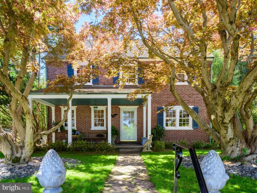 Step back in time and into a piece of Chester County history at 27 Dogwood Drive, a beautifully preserved home in the heart of the Hamorton Village Historic District. Originally built by Pierre S. du Pont to house workers of Longwood Gardens, this timeless brick home is rich with character, thoughtful craftsmanship, and enduring quality. As you turn onto Dogwood Drive, you quickly become immersed in the quiet and idyllic nature of the neighborhood. True to their names, the streets are lined with blooming trees inspired by their titles. Two mature Japanese Maples frame the front façade and invite you to venture down the central walkway that leads to the covered front porch, introducing the home’s character. As you walk through the front door into the entryway, you cannot help but to admire the beautiful hardwood floors and millwork throughout, enhancing the warmth and elegance of each space. The living room features floor to ceiling built-ins, a stunning stone fireplace, perfect for cozy evenings, and a set of French doors leading to the sunroom. The sunroom is a versatile living space that can be used as a sitting room, office, potting room and has large windows that showcase the vista beyond. The sunroom also contains a unique spiral staircase that connects you to the main staircase and through to the other side of the home. Circling back to the front of the house, to the left of the entry you will find the dining room that is open to the living room creating an ideal space for entertaining or relaxing with friends and family. Just off the dining room, a hallway leads to the eat-in kitchen that offers both style and function with ample cabinetry, a convenient side entry off the driveway, and panoramic views. A powder room, walk-in pantry and hallway closet complete this level. Upstairs you will find the color drenched primary bedroom suite, which was once two bedrooms and converted into one bedroom, with a stunning archway and custom millwork separating the sitting room/office. This space could be converted back into two bedrooms should the lucky new homeowner so desire. An additional bedroom of generous size includes an electric fireplace, two closets, and lots of natural light through several windows. The full hallway bathroom is beautifully tiled and well-appointed, continuing the home's thoughtful blend of vintage and updated details. The unfinished basement and spacious floored attic provide storage in this charming home, along with a detached two-car garage with attic space above for storage or workshop potential. Step outside to enjoy the serenity of a fully fenced backyard with young and mature landscaping, as well as a quaint brick patio and brick lined walkways. The rear level of the two-tiered yard is the perfect place for quoits or cornhole, while your fans watch from the gazebo. Behind the garage is a potting shed for our garden lovers. Located minutes from everything downtown Kennett Square has to offer and within easy reach of Longwood Gardens, everyday amenities, and major roadways (routes 1, 202, and 926), what’s not to love? This one-of-a-kind property is more than just a home—it’s a part of local heritage. Don’t miss your opportunity to own a piece of history with modern comforts—schedule your private tour today!