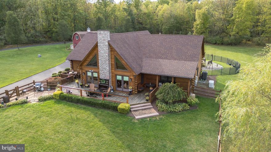 Like the sign says, "Little Bit of Heaven."  This beautiful Log Home located in New Hope Pa (In the Village of Point Pleasant) was built in 2017 under the direction of the current homeowner.   Meticulously constructed and maintained, you will immediately want to make this your new home.  As you enter from the main deck in the front of the home, you immediately find yourself in a large living space with a floor to ceiling fireplace anchored with majestic windows all the way up to the vaulted ceiling, which lets in the natural light.  The open floor plan carries you into the eating area/breakfast room and well appointed kitchen with stainless steel appliances.  A built in work space/coffee bar area finishes off the kitchen space.  Just off the kitchen, behind the barn door, you'll find a large walk in pantry.  The laundry is also off the kitchen before you enter the breezeway to the 31' x 23' garage.  The large breezeway adjoins the house to the garage which is equipped with an EV plug.  Back inside there is a large dining room that is currently being used as a billiards room.  Down the hall are 2 guest rooms and the hall bathroom with a tub/shower tastefully done with Travertine tile.  The primary bedroom at the end of the hall boasts a walk in closet and an attached primary bathroom with soaking tub, walk in shower and toilet closet.  The upstairs is a large open loft area that just invites you to sit and relax.  The owner finished off the upstairs storage area making it easily accessible and added storage space.  This Log Home is situated on 4.6 acres. The outside has an inviting front porch and a fenced in area with EP Henry walkway accents.  Don't miss "Giraffic Park" in the rear of the home that the seller will leave with the new owners if so desired. The private back yard is partially fenced in and has a very large EP Henry patio for all of your entertaining needs.  There is an additional detached garage that is currently used for storage and a work shop.  The solar panels and propane tank are owned by the seller and will convey with the sale.  The electric bill has consistently been below $15.00 per month and many months no payment is due. Don't miss out on the opportunity to own this "Little Bit of Heaven!"