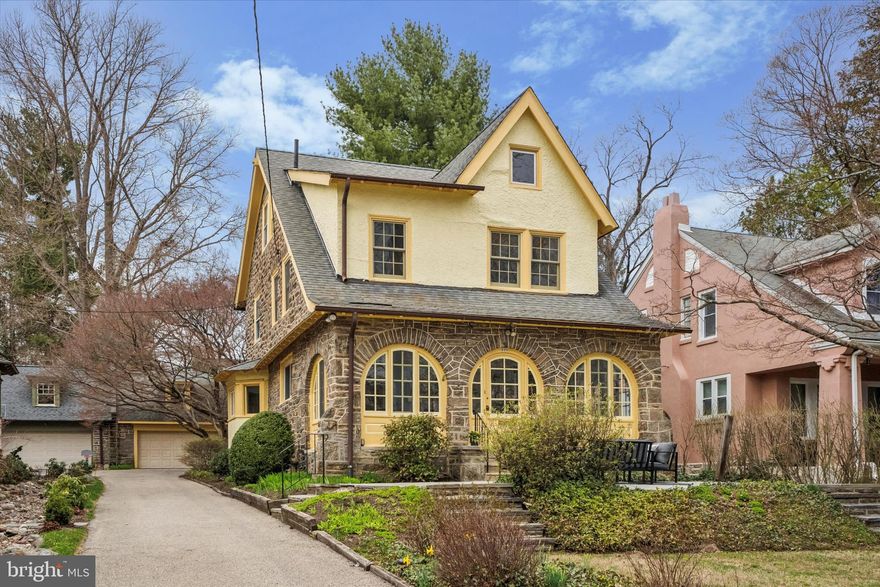 Enter a fairy tale setting at this beautiful West Mount Airy single-family home.  A private drive leads you past the front garden, where large specimen trees offer a warm welcome. Step inside and enjoy the spacious, light-filled solarium, perfect for morning coffee or midday meditations. The expansive living room features hardwood floors, a stone fireplace and skillfully crafted built-in shelving. Adjacent, the dining room opens offers a large bay window and ample space for entertaining. The completely renovated, generous kitchen and pantry have high ceilings, abundant cabinetry, contemporary appliances, and an alcove with a washer and dryer. A powder room completes the main level.

Step outside to the rear garden and be amazed. A canopy of incredible Japanese maples immediately surrounds you. Stone steps lead past a bi-level, two-car garage to a secluded "secret garden," a true refuge perfect for endless play and growth.

The second level houses three well-proportioned bedrooms and two full bathrooms. The primary suite includes an en-suite bath and dressing room. Next to the hall bathroom is a smaller, brightly lit bedroom. The rear of this level opens into a former sleeping porch, now offering stunning treetop and garden views. This unique space can be used in a multitude of ways, allowing your imagination to create your ideal home. The third floor features two tidy bedrooms, a full bathroom with a tub, and ample dry storage. The semi-finished lower level, with direct exterior access to the rear of the property, is ideal for a workshop, crafting, yoga, or play.

525 Arbutus has it all. Recent renovations include updated insulation, air conditioning and heating systems, contemporary windows, new wiring, full kitchen, and primary suite. The highly sought-after West Mount Airy Village location, enveloped by the lush landscape of the Wissahickon Valley, provides easy access to the footpaths of both the Big and Little Woods. Complemented by the rare convenience of High Point Cafe, a cooperative market, and other local staples, this setting is truly unbeatable. Make 525 Arbutus your own!