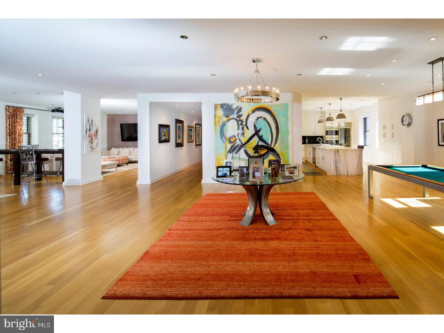 Open up the doors to a world of modern luxury and unprecedented privacy with this one-of a-kind completely custom 4 bedroom, 4.5 bathroom penthouse on Rittenhouse Square! Spanning over 5,000 square feet, this contemporary custom home features separate elevator access, direct freight elevator access in-unit, and is surrounded by 6 non-party walls for total privacy. Custom designed from raw space, this modern, luxurious 4 bedroom home features a rare and spacious open layout with pristine hardwood floors, 10.5' ceilings, ample recessed lighting, windows in every room for incredible natural light, 3-zone Nest smart thermostat, and beautiful custom gallery lighting throughout. This bright and open home features a chef's kitchen with dramatic one-of-a-kind marble island, soft-close custom lit cabinetry, large double windows, Wolf double oven with 2 warming drawers, Wolf induction cooktop with built-in grill and steamer, extra deep stainless steel sink with instant hot water, Grohe fixtures, Asko dishwasher, Sub-Zero French door refrigerator and freezer, and full-size Sub-Zero wine refrigerator. The grand entryway features 2 coat closets with built-in storage. A spacious dining area with ample seating and large double windows extends into an open entertainment space off of the kitchen. Off of the home's open foyer is a large living area and den separated by a stunning built-in marble top bar with built-in glass shelving. Both rooms offer oversized windows and generous natural light. The den features built-in shelving, a 12' Da-Lite projection screen, Sony projection system, and Yamaha 5.1 surround sound. 2 of 3 guest bedrooms are situated off of the main entryway. Both feature walk-in closets, large windows, and ensuite bath with modern finishes. A separate laundry room contains a Whirlpool Cabrio Platinum large capacity washer and dryer, tile floor with built-in drain, and built-in custom shelving and cabinetry. The third bedroom (currently being used as a home office) features double windows with William Penn views, walk-in utility closet with built-in shelving, and ensuite bath. A spacious master features oversized windows, custom walk-in closets, Royal brand sauna, and custom ensuite bath with groutless stone tiled rain shower, Air Jet soaking tub, Duravit ceramic sink, oversized double vanity, custom wood cabinetry, and commode.