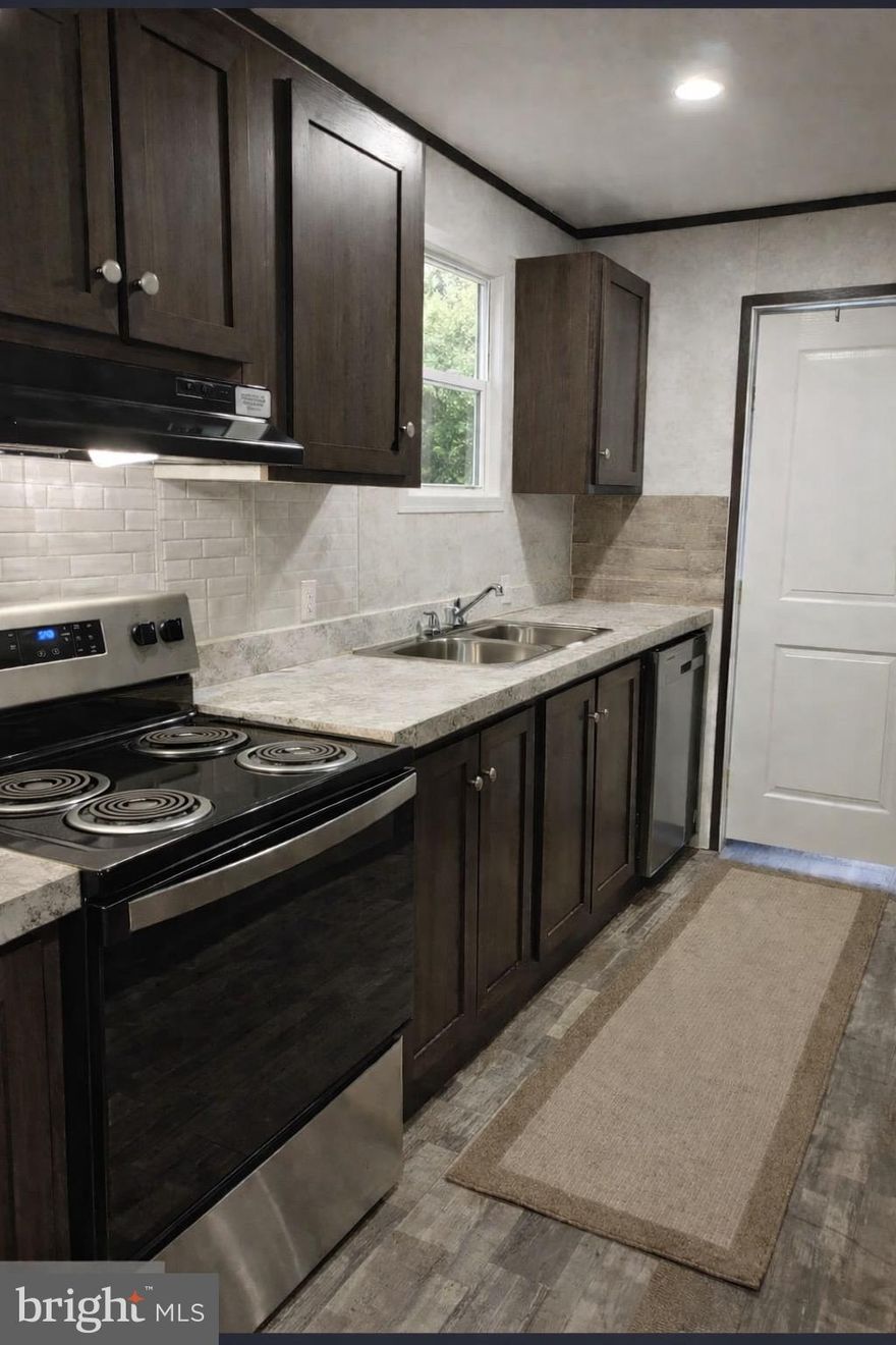 Welcome Home!     Very cozy and comfortable 2023  Manufactured  Mobil Home.   A single - wide  home with two full bathrooms is rare,  it brings a high -value for this specialized layout. Both bathrooms have a  tub and shower, nice and spacious.  Very unique  style  which gives you a cottage looks  with contemporary  style . Quiet , nicely  maintained  park. This home  is located on the corner lot with 3 car parking spaces .  Spacious living room, kitchen , bedrooms with ceiling spot lights . Master  bedroom  has a master walking closet with   lots  of space .   Separate Laundry room with back glass door that gives you  day light and sun light. Central AC  was just installed last year. This Home has central AC and central heat. New appliance. Very convenient to all major highways .   Just move inn !