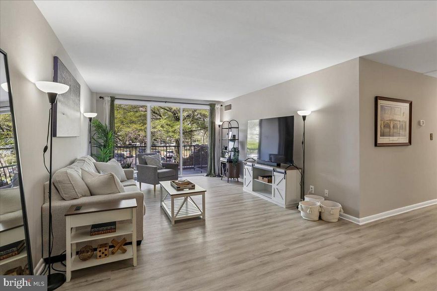 Bethesda’s best value just got even better at Whitehall - #211! This beautifully updated two-bedroom residence offers ample space, natural light, and thoughtful renovations, all tucked away on the quiet side of the building. It features a private balcony overlooking lush, tree-filled surroundings. As you step inside, you'll notice the updated flooring that flows seamlessly throughout the home, complemented by expansive living and dining areas filled with natural light from oversized sliding glass doors. The open, functional layout promotes effortless everyday living and is perfect for entertaining. The renovated kitchen boasts crisp white cabinetry for all your essentials, granite countertops, and stainless steel appliances, providing both style and practicality. Down the hall, two generous bedrooms offer flexibility for comfortable living or a work-from-home setup, with the spacious primary bedroom easily accommodating a king-sized bed. The bathroom has been tastefully refreshed, featuring ceramic tile, an upgraded vanity, and sleek black fixtures for a modern finish. Set on seven landscaped acres, Whitehall provides residents with amenities such as an outdoor pool, fitness center, concierge service, on-site management, and ample parking. It is ideally located near the Bethesda and Medical Center Metro stations, granting immediate access to shopping, dining, and grocery stores, including Room & Board, Anthropologie, the Apple Store, Madewell, Olazzo, Hip Flask Rooftop, Harris Teeter, and Trader Joe's. Residents also enjoy quick routes to Washington, D.C., Northern Virginia, and major commuter corridors. This is an exceptional opportunity for first-time buyers, investors, or anyone seeking a turnkey pied-à-terre in Bethesda!