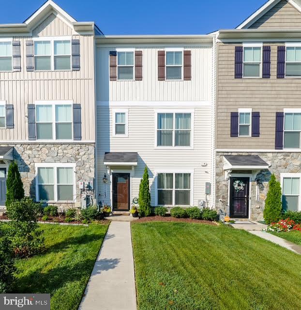 Welcome to this beautifully designed townhome! Inside and out is well maintained and waiting for you! This residence features an open- concept living area, with a spacious kitchen with stainless steel appliances, pantry, granite counter tops and a large island ready for entertaining. A bright living room space off the kitchen. The upper level host 3 bedrooms, washer and dryer, the spacious primary suite has a vaulted ceiling , a walk in closet and a private bath, lower level has 4th bedroom with full bathroom. The front is beautifully landscaped and the back has a private balcony off the living room is perfect for your morning coffee, relaxing or entertaining. This home has a two car garage in the back of the residence. Located just minutes away from shopping, dining, Metro station, and major commuter routes. Don't miss this opportunity.