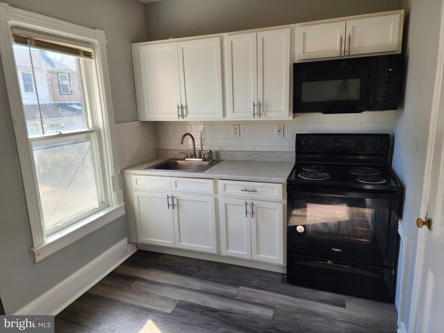 Welcome to 114 N 5th Ave, a well-appointed 1-bedroom, 1-bath lower-level rental in the heart of Coatesville. This inviting unit features hardwood flooring throughout, creating a warm and timeless feel. The modern kitchen is beautifully designed with sleek white shaker cabinets, offering ample storage and a clean, contemporary aesthetic.  Enjoy your morning coffee or unwind in the evening on the charming front porch. Conveniently located near major highways and public transportation, this home provides easy access to everything you need. Rent is $1,200 per month, plus utilities.  Don’t miss this opportunity—schedule your showing today! No Pets.