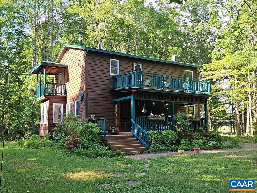 Lovely and artsy home with large, inviting porches, comfortable living spaces, large kitchen with new countertops, three cheery bedrooms, 1.5 baths, covered deck off of primary bedroom, huge workshop with 3 bays and an extra room with wood stove. Lumber shed, in ground Greenhouse ! raised garden beds with covering, flowers everywhere even Lady Slippers !, and all of this on over five acres that are mostly wooded. A tinkerer's and gardener's dream, this property is also prepared for warm, cozy winters with a robust wood stoves, plenty of windows to let the sun shine in, and a large shed to store lumber. Recent upgrades include painting the large shop roof, painting the bedroom balcony, and brand new (installed 5/8/25) metal roof. This on is a keeper and an excellent investment for many years!!!,Fireplace in Dining Room