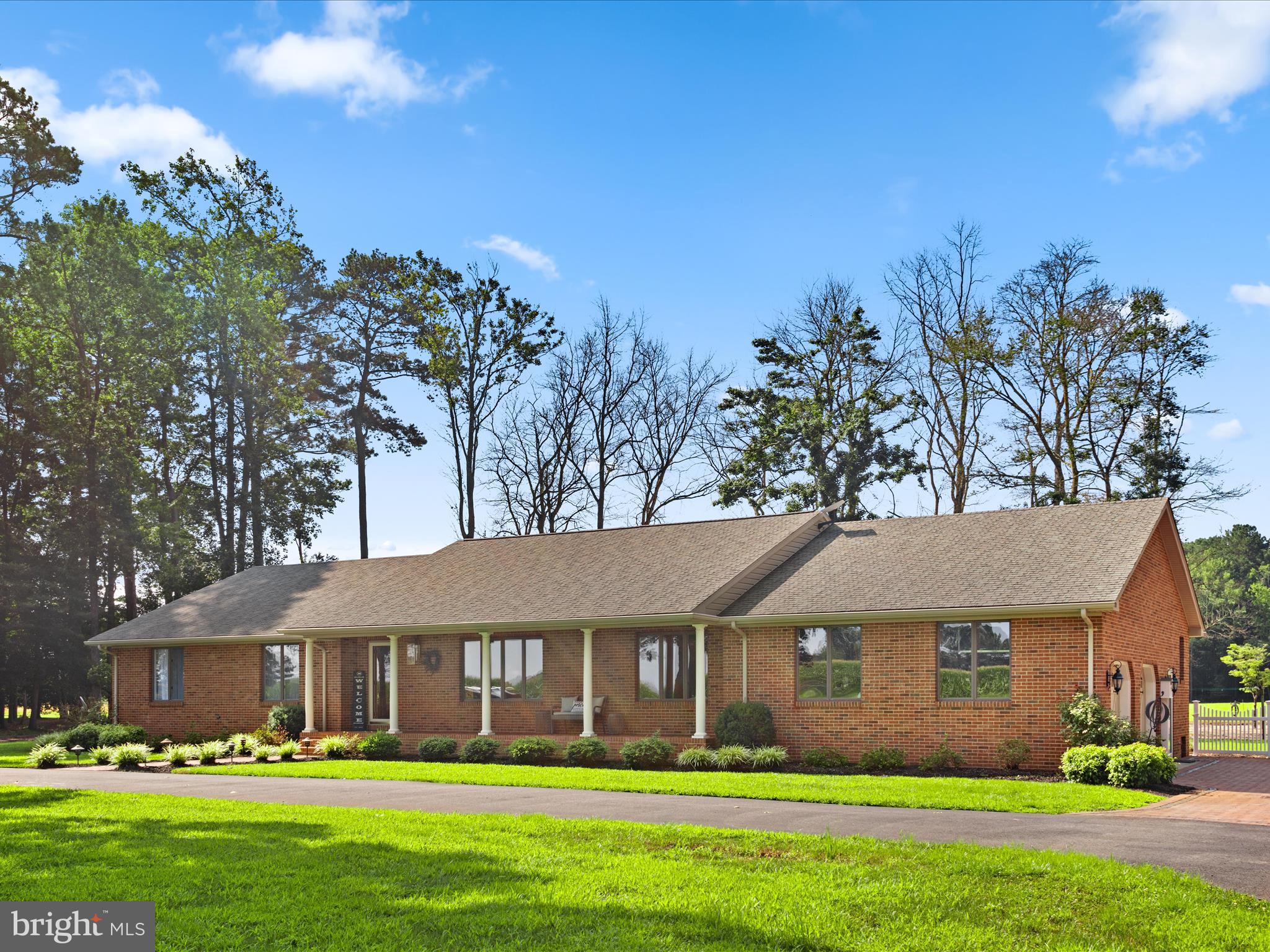 Privacy abound on this sprawling homesite consisting of 3 continuous parcels totaling over 43 acres.
The meticulously maintained custom built brick rancher, offering 3 Bedrooms and 2.5 bathrooms, is generously situated on the first 12.9 acre parcel accompanied by an additional 24x32 finished detached garage/workshop and a 48x24 machine shop surrounded by 26.60 wooded acres with an additional 4.55 acres currently leased to a farmer.
Serenity encompasses you upon arrival as you pull into the black top circular driveway leading to the inviting covered front porch or follow the expansive custom brick pavers to the attached oversized 2 car garage.
The charm continues as you enter the foyer, adorned with ceramic tile flooring, to the right you’ll find the formal living and dining room- both showcasing the original hardwood flooring and ample picturesque windows. As you continue through the foyer you’ll find the hallway leading to the bedrooms, primary suite and full hall bathroom, offering privacy from the main living spaces, before opening to the spacious family room with gorgeous granite gas fireplace flanked by sliders on either side leading to your paved back patio with custom gazebo and dedicated gas line for your grill.
Flowing seamlessly, the family room transitions to the true heart of the home- the gourmet kitchen is a chef’s dream boasting a sun drenched breakfast nook, commercial 6 burner Viking gas cooktop and hood, Wolfe wall oven and convection microwave, Sub Zero refrigerator adorned with oak panel door- flowing seamlessly with the custom oak cabinetry. Accented by gleaming granite countertop, the island with prep sink accompany the large peninsula holding the double drawer dishwasher and deep stainless steel sink. Additionally you’ll find pull out spice racks, Kichler LED under cabinet lighting, instant boiling water tap and pot filler, to name a few of the thoughtful installed enhancements.
Off the kitchen you’ll find the spacious mudroom hosing a Speed Queen commercial washer and dryer, powder room, a large pantry and an additional foyer leading to the oversized attached garage which host the geothermal heating and cooling system, tankless water heater and top of the line filtration system.
At the end of the hall you’ll find two generous sized bedrooms with hardwood flooring and a full bathroom with a stunning quartz countertop top, a custom-made vanity, porcelain ceramic tile and glass trim in the tub/shower. The spacious primary suite showcases hardwood flooring and a spa like ensuite with Kohler shower system with dual shower heads, body sprayers and a dedicated hot and cold water line, accompanied by porcelin ceramic tile flooring, granite vanity to and custom California Closet walk in closet.
Rounding out the interior you’ll find a second floor finished space, with its own HVAC system, offering endless options from expansion, storage, office or massive playroom. Accompanied by unfinished storage space on either side the options are truly endless with this flex space.
This enchanting park-like setting has to be experienced first hand to be truly appreciated… Whether you’re looking for the utmost privacy or to be able to hunt from the comfort of your own property- from hobby farm to grand garden the options are endless with this one of a kind picturesque property. Conveniently located to Salisbury, Delmar and with a nominal commute to Ocean City and the Delaware beaches.