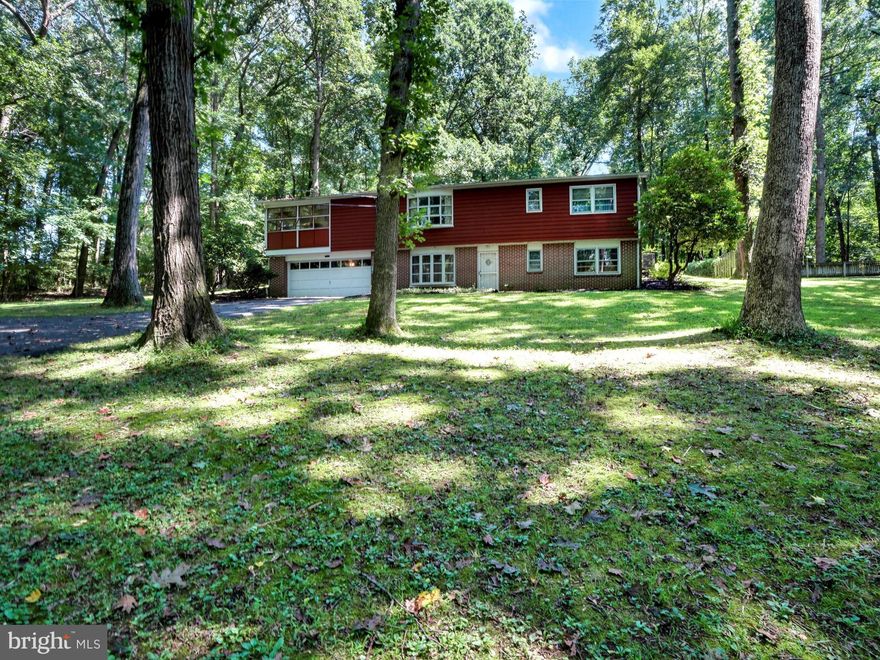 Peaceful - private - serene- blissful.  All of the above describe the setting for this mid-Century raised rancher featuring over 2,100 sf of finished living space. Beautiful hardwood is hiding under the existing carpeting throughout the main floor.    The home has 3 bedrooms and full bath on the main floor and another bedroom and full bath on the lower level which exists to a brick patio that overlooks the beautiful scenic backyard which is a nature lover's dream!  The lower level is also host to a cozy family room complete with a wood-burning fireplace.  Enjoy the changing seasons from the screened-in porch.  Don't miss this opportunity to own over 2 acres of tranquil wooded bliss!  The possibilities are endless!