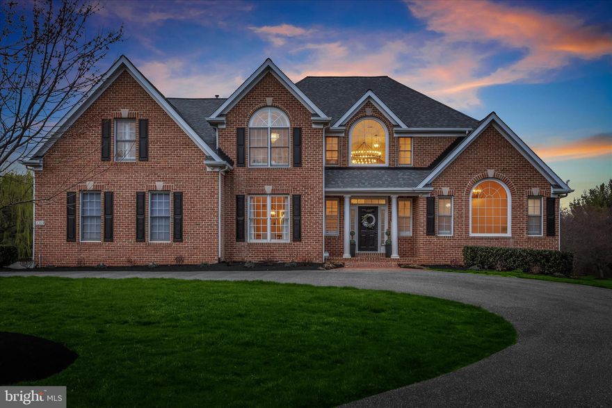 Nestled on a picturesque one-acre lot in the desirable Fox Valley Estates community, this incredible brick colonial has been thoughtfully reimagined with over $300,000 in updates. A circular driveway welcomes you home, leading to an attached three-car garage with pristine epoxy flooring. Located on a peaceful cul-de-sac, this legacy home boasts design-inspired interiors and breathtaking sunset views over rolling pastureland and neighboring horse farm. Step into the impressive two-story foyer, where a striking candelabra chandelier and a modern turned staircase set a grand tone. To the left, the formal dining room showcases crown molding and chair railing, and the living room dazzles with soaring two-story ceilings and dramatic windows that flood the space with natural light. At the heart of the home, the stunning kitchen is a chef’s dream, featuring newly updated white cabinetry with dentil molding, a glass tile backsplash, granite countertops, a spacious island with a breakfast bar, high-end Z Line stainless steel appliances, a walk-in pantry with custom organizers, and stylish new hardware and fixtures. Adjacent to the kitchen, the breakfast room’s cathedral ceiling and deck access provide the perfect spot to enjoy morning coffee with an uninterrupted view of the horse farm. The family room is a breathtaking retreat, complete with a two-story vaulted ceiling, a floor-to-ceiling brick fireplace, and two expansive picture windows that frame the stunning landscape. The main-level primary suite is a private sanctuary, offering a spacious bedroom with a cathedral ceiling, an attached sitting room with French doors, and tranquil views of the farm. Luxuriate in the really updated en-suite bath, which features a newly installed double vanity, a soaking tub, and a separate shower with newly installed shower doors, and custom wooden plantation shutter blinds. Two walk-in closets with custom built-ins complete this elegant space. Two staircases lead to the upper level, where four sizable bedrooms await. Two bedrooms share an attached bath with a double vanity, while the third and fourth bedrooms share a dual-entry bath. Custom closet systems enhance three of the four bedrooms, and each space is adorned with new lighting, mirrors, and freshly painted vanities. The fully finished lower level is a showstopper, accessible from both the kitchen and the foyer. This expansive space boasts a sprawling recreation room, a full bath, a private exercise room with commercial-grade flooring, and a luxurious theater room. With a walkout to the backyard, this level is as functional as it is impressive. Outdoor living is just as exceptional, with a newly installed composite deck featuring glass panels designed to maximize the breathtaking views. Additional exterior enhancements include a professionally installed Hi-K video and audio monitoring system, a Ring Alarm doorbell, upgraded exterior lights, an invisible fence with monitors, and over $10,000 in professional landscaping. The garage is equipped with a WiFi-enabled door, video monitoring, and a workspace with additional shelving. Throughout the home, meticulous upgrades enhance both form and function. LVP flooring, modern hardware, and stylish lighting fixtures. All door hinges, outlet covers, and toilets have been replaced, and the foyer staircase has been redesigned with updated spindles, and a brand-new chandelier. Smart features include WiFi-enabled garage openers, touch keypads, and remote-controlled custom blinds in multiple rooms. Major system upgrades include a new water heater (July 2024), furnace (June 2020), a pumped and serviced septic system (December 2024), and a Landmark Pro Shingle roof installed in April 2014 with a warranty. A true masterpiece of thoughtful design and meticulous updates, this extraordinary home offers unparalleled elegance, comfort, and security in a coveted community setting. Don’t miss your opportunity to experience it firsthand.