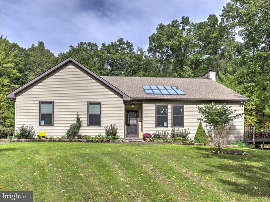 Find this wonderful 6.3 acre woodland retreat tucked away on Deer Trail Dr.  Enter the front door to the expansive great room - a beautifully tiled, open-concept living room, dining room and kitchen with large skylight and custom wood-burning fireplace.  The fireplace was crafted from Schuylkill County Mountain Stone.  The mantle was formed from one of the property's Hemlock trees.   French doors lead to the generous deck for relaxing and entertaining.  Also on the main floor are 4 bedrooms, 2 full baths and the laundry room.  The master offers an over-sized bath with stand up shower, claw foot tub and his-and-hers closets.  Step through the sliding door from the master onto a private deck already wired for a hot tub.  Downstairs find over 1600 sq ft of additional living space, which includes 2 optional bedrooms, a family room with kitchenette, a half bath and a fully equipped fitness room with sauna.  A brand new HVAC Heat Pump was installed this year, as well as new carpet, tile and paint throughout.  Electric baseboards and a Reading coal stove can provide back-up heat.  The attached 2 car garage offers a large ready to be finished second floor for your home office or other needs.
