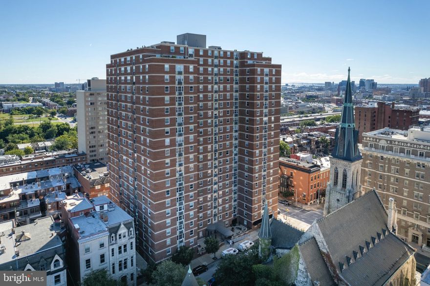 Experience elevated urban living in this beautifully renovated 1-bedroom, 1-bath condo in the heart of Mount Vernon. Perched on the 7th floor of a secure, doorman building, this stylish unit blends historic charm with modern upgrades. the unit has since undergone a complete transformation. The kitchen has been fully transformed and reimagined with sleek under cabinet lighting, an electric cooktop, built-in oven and microwave, dishwasher, and garbage disposal, creating a space that’s both functional and elegant.

Refinished hardwood floors run throughout the unit, enhancing the warm and inviting atmosphere. The bathroom has been completely remodeled with granite tile floors, a new sink and countertop, a backlit mirror, and a classic tub/shower combo. A custom brick accent wall adds a touch of industrial style to the space. The bedroom and living room are both outfitted with solar shades, offering privacy while still allowing soft, natural light to pour in.

Comfort is key with a brand new HVAC system installed in 2020—a Carrier 1.5-ton 14 SEER heat pump with a smart Nest thermostat—recently serviced in January 2025. The water heater shutoff valves were also replaced in April 2025, giving peace of mind to the next owner. A dedicated storage unit (#6) is conveniently located on the same floor, and parking is available for a monthly fee in the garage directly beneath the building.

The building itself offers 24-hour doorman service, an on-site convenience store, and a comprehensive HOA that currently includes water, trash, building insurance, and common area maintenance.  Situated in one of Baltimore’s most walkable and culturally rich neighborhoods, this condo places you just steps from restaurants, cafes, museums, and transit—making it an ideal home for city lovers, first-time buyers, or savvy investors alike