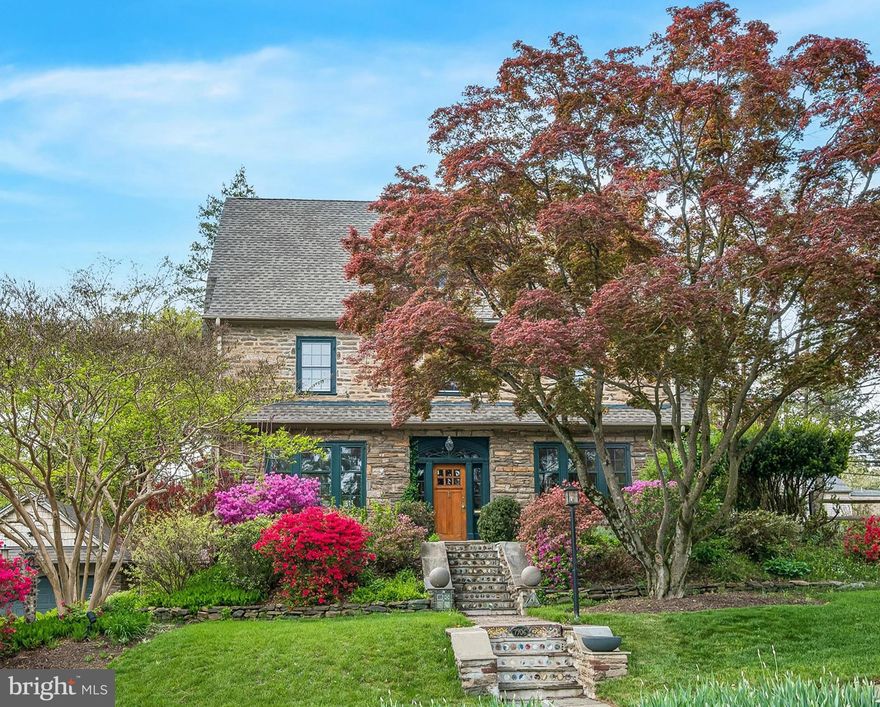 Set on a leafy secluded Elkins Park cul-de-sac, this stone Dutch colonial welcomes you! A bright foyer leads you to a living room featuring large windows that bring the outside in, plus a wood burning fireplace with Mercer tile surround. Move through the living room to access an enclosed sun porch with French doors that open onto a stone patio and lush, landscaped gardens. Back inside, across from the living room sits an elegant formal dining room, where you can enjoy the view through the bay window while you and your guests dine. From the dining room, another set of architectural French doors leads you to the modern kitchen with abundant cabinet space, modern appliances, granite countertops, and a cozy breakfast bar. Downstairs, the basement boasts a laundry room and a separate utility area, plus a large room that you could make into a family room or work area. Next, head upstairs to the second floor, where the master suite awaits, complete with a remodeled bathroom and a private deck. This suite offers a connected study as well, which could be used as an office or nursery. Two more bedrooms and a full bath complete the second floor, and the third level has two full size, full-height bedrooms and a full bath with clawfoot tub. When you are ready to head out, this home is also just minutes from the Elkins Park's charming town center, as well as the Elkins Park Regional Rail station, multiple bus stops on York Road, and access to Rt.309. Come visit this lovely retreat today!