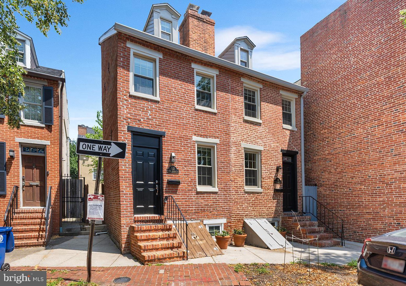 Welcome to 112 W Montgomery St – a historic, fully renovated, light-filled end unit rowhome nestled in the heart of one of Baltimore's most sought-after neighborhoods, Otterbein. Built in 1836 and renovated in 2024 by its owner with a mid-century modern aesthetic, this home is full of thoughtful details and modern amenities. The kitchen and bathroom include plumbing and electrical were replaced. A new roof/gutters/downspouts, new double pane/double hung windows were installed. New HVAC was installed in 2020. Step inside to discover a thoughtfully designed living space – capturing the Danish ‘hygge’ sense of comfortable conviviality. The home features two cozy bedrooms with all new lighting, outlets and 2 closet spaces. The modern kitchen is updated, boasting new tile backsplash, new marble checkerboard floors, new electric range, fridge, and glass pendant light. The stylish bathroom includes a Pottery Barn vanity and mirror, Toto toilet, new bathroom fan and lighting. The light-filled living area is enhanced by a brick fireplace and oak flooring, adding a touch of elegance and warmth to the space. Outside, you'll find a very large, serene, fenced courtyard with mature trees, decking and mulch area, perfect for enjoying the outdoors or entertaining guests. Equipped with central air conditioning and heating replaced in 2020, this home ensures year-round comfort. The convenience of an in-unit washer/dryer adds to the home's appeal. The basement with window provides extra storage or potential for customization to suit your needs. Tucked into a quiet, one-way street with ample District 8 Otterbein permitted street parking making it a prime location without the crowds. Close proximity to the Otterbein Swim Club, Inner Harbor, Light Rail, Camden MARC train, South Baltimore Peninsula, M & T Bank Stadium and Camden Yards make this the perfect urban oasis. Easy access to I-95 and transit makes commuting a breeze. Don't miss the opportunity to make this charming townhouse your new home. Schedule a viewing today and experience the perfect blend of comfort, history, style, and convenience at 112 W Montgomery St.