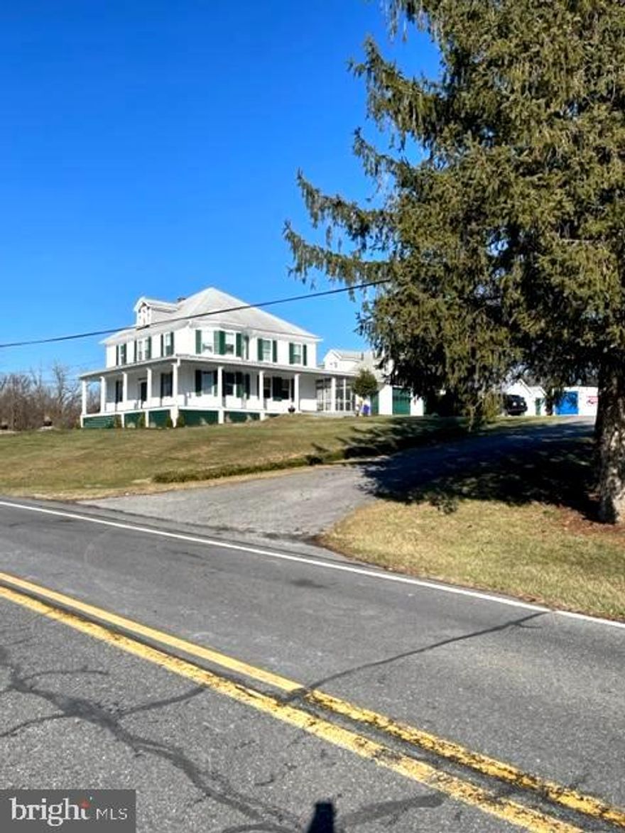 This amazing Victorian home has a view of the mountains.  The home has beautiful hardwood floors on the main level, large windows, and high ceilings.  The formal living room has built-in bookcases.  There is another room on the main level that can be used for a family room, music room, etc.  The main bath has marble flooring.  Large bedrooms are located on the second floor.  The rear of the house has a screen porch.  The guest house, with two bedrooms, is a diamond in the rough and can be made into an in-law home or an office for a business.  The 15.40 acres contain 5 garages, a barn, and a heated doghouse.  Property is being sold As-Is.