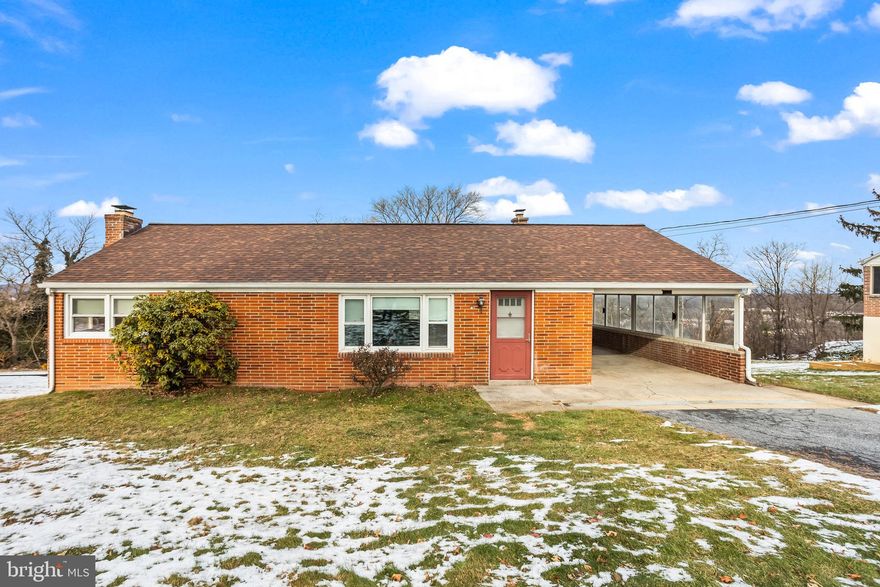 Brick rancher on nearly 0.5 acres offering a rear redwood deck with a open view of the property. The main level includes hardwood floors, replacement windows, three bedrooms, central air, and a remodeled full bath. The finished walkout basement adds functional space with a fireplace, bar area, full bath, and direct access to the yard. Exterior features include a carport and ample yard space for outdoor use.