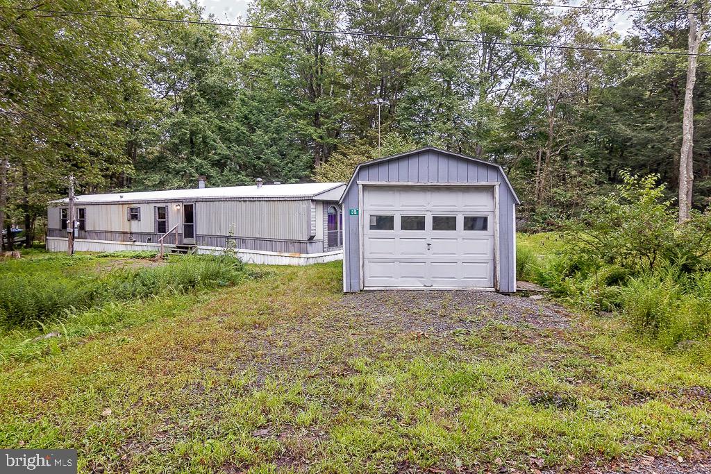 We Have A Spacious Living Room with Propane Fireplace, Dining Area With Built-In's And Kitchen With Breakfast Bar. There Are 3 BRs, 2 Full Baths And The Laundry Room. Most Home Furnishings And Appliances Are Included. Property Taxes Are About $625 And Dues are $450 Annually. You Own The Land And There Are No Additional Monthly Fees Here! The Home Is Located 15 Minutes From Gouldsboro State Park And Only 25 Minutes To The Shores Of Lake Wallenpaupack In The Community Of Indian Country. A Golf Cart Friendly, Amenity Filled, Community With Clubhouse, Playground, Basketball Court, Swimming Pool And Stocked Fishing Lake. Trash Disposal Is Also Included In Your Dues. So, Whether You Desire A Pocono Get-A-Way Or Just Want An Economical, Full Time Lifestyle, This May Be A Perfect Fit!