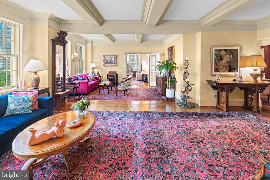 Exquisite and sumptuous Rittenhouse Square Condo. The 10th floor of 1900 Rittenhouse Square is the perfect elevation to enjoy both the treetops of Rittenhouse Square and the architecture of the buildings surrounding the park. Created by joining two units, this residence offers a grand-scale living area, spacious, updated eat-in kitchen, formal dining room plus 3 bedrooms, 2.5 baths and a full-sized laundry. Its herringbone hardwood floors are timeless; there’s wall space for art and substantial millwork for touches of old-world visual interest. The kitchen is outfitted with a wealth of storage, including an attached “Costco Closet.” A Viking six-burner gas range and vents hood will serve the home chef (or caterer!) well. It’s rare to have a city kitchen with this amount of counter space and cabinetry. There is a charming breakfast/casual dining nook in the kitchen complete with window. The dining room is sized to accommodate a crowd and has beautiful millwork and broad 8-over-8 windows. With multiple seating areas and its direct Rittenhouse Square views the living room is perfect for entertaining. The evening cityscape is sure to enchant. Also facing the Square, the sizable 3rd bedroom, presently used as a study offers many costumed built-ins. A hall bath finished in Carrera marble and a linen closet serve the second bedroom.  The romantic main bedroom suite is a true haven and features a deluxe bath with soaking tub, glass-enclosed stall shower, double vanity, plus a walk-in closet. Yet another hall walk-in closet, powder room, laundry and additional basement storage complete this haven on the fully residential south side of the Square. Enjoy this doorman building and easy access to the many restaurants and shops that are a central part of the appeal of an address on the Square and all that Center City has to offer.