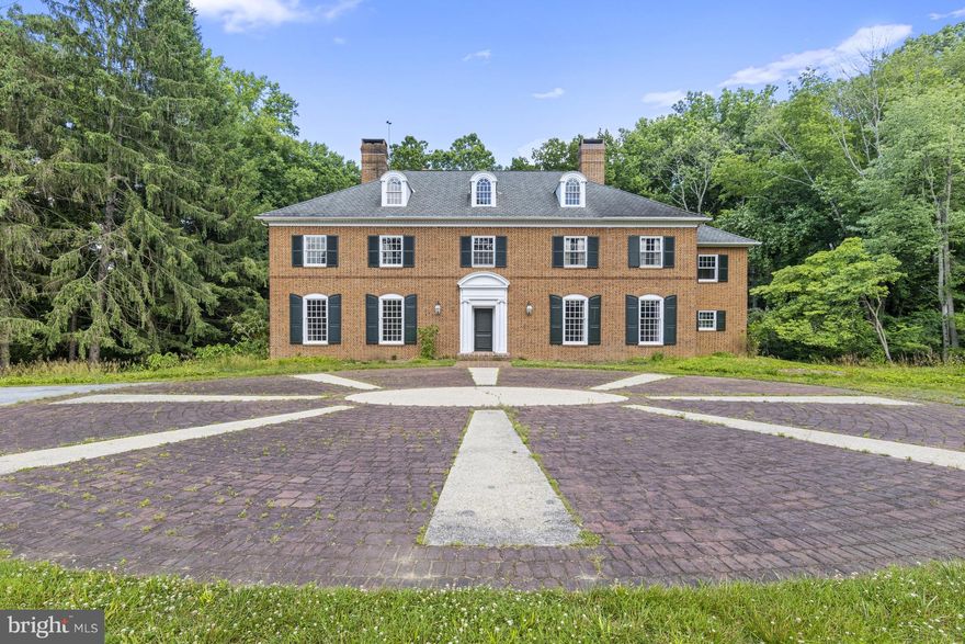 This classic Brandywine Valley estate sits tucked off of Hickory Hill Road in Pennsbury Twp on a picturesque 23-acre lot with rolling hills and partial wooded areas. This private location is immersed in nature and offers a blank slate for a future retreat from the large nearby hubs. A long driveway wends through verdant pastures past the original spring house to the breathtaking brick colonial home. A stately brick courtyard entrance welcomes you. Much of the home has been gutted to create a perfect canvas for a future dream home. Many of the original details remain including the grand 2-story turned staircase, soaring 10' ceilings, 5 classic fireplaces, timeless hardware and millwork and original wood floors on the second floor. Immediately begin to envision your future home as you pass through large rooms including the living room, dining room, library/family room and primary suite. The footprint currently offers the option for 5BR and 3.2 baths. A second turned staircase leads to the massive unfinished 3rd floor. Additionally the unfinished lower level walk-out provides more square footage with concrete floor and high ceilings. A sweeping brick patio sits off the rear of the house and overlooks a stunning and serene view of the wooded area surrounding the yard. The grounds are a nature lover’s paradise and include a 2-story bank barn, currently concrete flooring and can easily be converted to stalls for horses, equipment or any number of options. This home is located in the Unionville-Chadds Ford school district and is just minutes from downtown Wilmington Amtrak Station, Chadds Ford and Philadelphia airport.