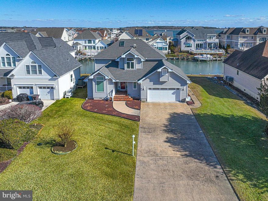 Gorgeous views of the Ocean City skyline await you, straight down the canal from your 80 feet of water frontage! A concrete walkway and brick entry porch welcome you to this Terns Landing contemporary home with a unique design. Load up your boat just steps from your back door at your private boat dock with motorized lift. Numerous outdoor living areas take advantage of the water views. Two balconies, rear deck, and a three season room leave plenty of room for outdoor entertaining. The kitchen was newly remodeled three years ago, including beautiful marble look floors, quartz countertop, stainless steel appliances, pantry with pullout shelves, built-in desk, and a breakfast area with access to the partly covered deck.  Two archways lead into the family room with hardwood flooring and a gas fireplace.  A large utility room, formal living and dining rooms, full bathroom, and a  two car garage with workbench and cabinets, are all accessed easily from the tiled entry foyer. The second level is brightened by two skylights, a conveniently located laundry area, two guest bedrooms, and a primary suite featuring a large walk-in closet, balcony access,  tiled bath with glass door shower and large whirlpool tub. There’s lots of storage space in the attic, accessed through a bedroom closet. Many  items have recently been replaced - the boat lift and HVAC units in 2021, the fireplace & water heater have been replaced, and the roof is 10 years old.  Make Terns Landing your new address!!