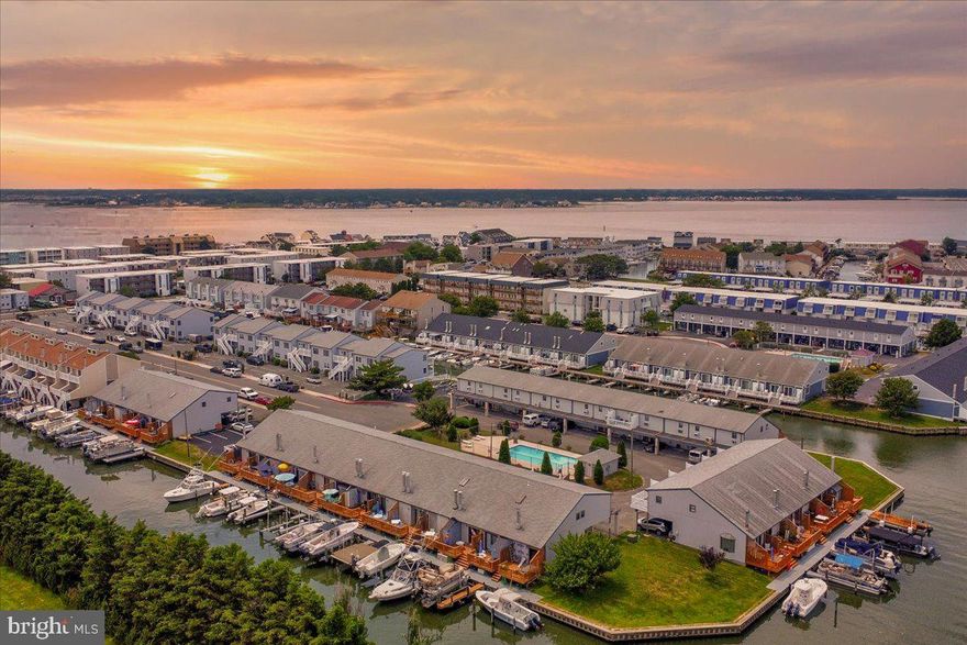 Welcome to Old Port Cove #9, a stunning two-story condo offering the perfect blend of coastal charm and waterfront living.   Currently enjoyed as a 2 bedroom property that has been transformed from the original 1 bedroom design.  Additionally the spiral staircase has been removed and replaced with increased functionality with permanent stairs.  As you step inside, you'll be immersed in the open-concept layout, where the kitchen, dining, and living areas seamlessly lead to a private balcony/deck overlooking the canal. Boating enthusiasts will love the convenience of having their own private boat slip, with deeper water that will accommodate a larger boat and providing easy access to the Bay and Ocean in just minutes.   Old Port  Cove is a well run association with a great community pool and ideally located with easy access to the beach and boardwalk.  This waterfront gem is ideal for a vacation getaway or year-round living. Don't miss this incredible opportunity—schedule your showing today!