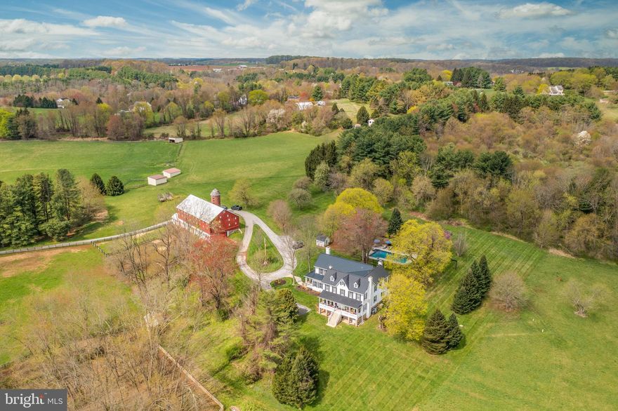 Quality of life awaits the new owners of this picturesque farmette, which offers idyllic country living just 20 minutes from Hunt Valley. Cross the bridge over the Little Falls onto 38 acres where Highland cattle graze and free-range geese and chickens roam. Property includes well-maintained 1870s bank barn (set up for cattle and hay/equipment storage) with electric and water, restored silo, and large chicken coop that connects to a fenced chicken run. Approximately 20 of the 38 acres are newly fenced and used for raising Highland cattle and goats; other acreage is currently used for hay. The home also dates to the 1870s though it's been meticulously maintained and upgraded for modern living. The home sits on a hillside overlooking pastures, a pond and spring house. It has kept its historic charm, including a colorful stained glass transom window over the original front door, wood floors, four wood burning fireplaces and one gas fireplace, and original mantles. Yet a modern family will find every convenience: an exquisite master suite remodeled with cathedral ceilinged office; 4+bedrooms, 4 full, updated bathrooms, and a gourmet kitchen. Adjacent to the kitchen is a large family room with a stone bar and wine storage and egress onto the expansive, covered patio shaded by mature Norway maples. Steps away is a newly refinished, fenced pool equipped with wireless speaker system and nestled into a terraced English cottage garden. Whether seeking a family compound, a hobby farm, or simply a rural retreat, this home has the features for any lifestyle.