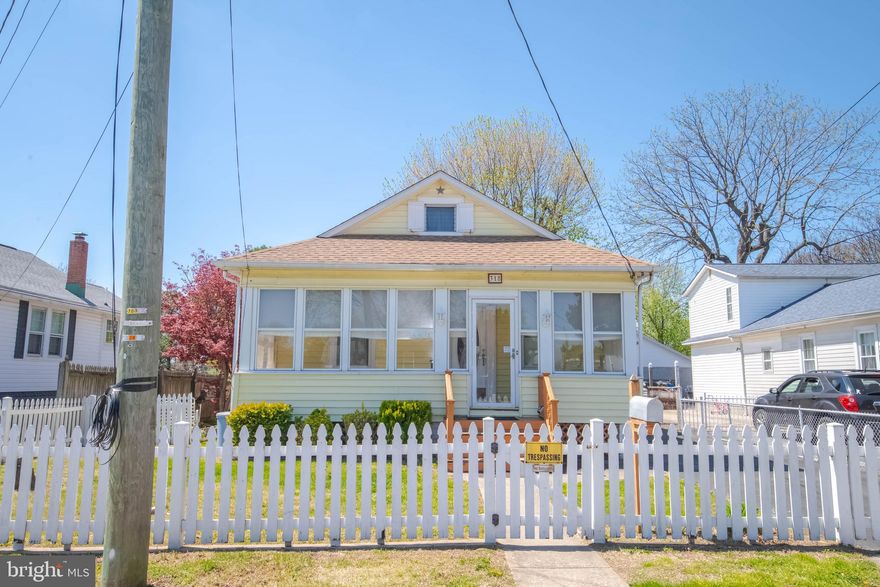 Welcome to this cute home in the heart of Essex. offering a fantastic opportunity to make it your own.  While the interior could use some cosmetic updating the price  reflects an opportunity to add your personal touches.  The roof was replaced in 2022, giving added peace of mind for years to come. Enjoy relaxing mornings or evenings in the enclosed porch, and take advantage of the partially finished basement for additional living or recreational space. The home also features convenient off-street parking and a level, fully fenced yard—perfect for outdoor gatherings, pets, or play. Being sold as-is, this property presents an excellent value for buyers looking to customize a home.  This property is close to the local elementary school and Coxs Point waterfront park.