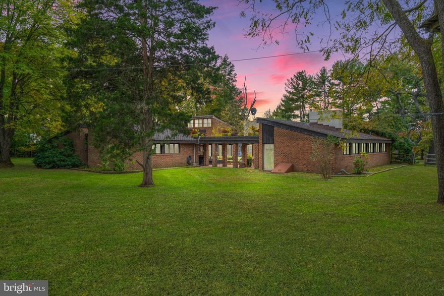 Welcome to 420 Cathcart Road, a remarkable mid-century modern, Frank Lloyd Wright-inspired custom contemporary home. Located in the highly sought-after neighborhood of Blue Bell, and situated in the consistently ranked blue ribbon school district of Wissahickon. As you approach the home, you'll be greeted by the stunning brickwork that sets it apart from the rest. Take pride in owning a home built with brick from a true American patriarch's Construction Company, Mr. John B. Kelly; the father of the late Princess of Monaco, Grace Kelly. 

With 5 bedrooms and 5 baths, this magnificent residence boasts cathedral ceilings that create an airy and open atmosphere. The interior features are truly impressive, starting with the smart home technology that ensures convenience and efficiency. Step through the new custom front door and admire the craftsmanship throughout. Prepare to be amazed by the exceptional features and luxurious finishes found in the newly remodeled kitchen. Swoon over the custom soft-close cabinetry, elegant fixtures, and top-of-the-line Dacor appliances, such as a steam oven, built-in warming drawer, and microwave. The Italian glass backsplash in the kitchen creates a sleek texture that serves as a striking focal point, perfectly complementing the rich quartzite counters. A sprawling kitchen island completes this space, designed with functionality in mind with its generous countertop prep station. This kitchen is a culinary enthusiast's dream come true! The seamless flow and timeless beauty of the hardwood floors elevate the overall aesthetic of the dining and living room. The elegance of the pass-through gas fireplace serves as the center of attention here, filling these rooms with warmth and comfort. Close by, discover the perfect blend of productivity and relaxation with a convenient office space, complete with a cozy fireplace.  The primary suite offers a walk-in closet with custom built-in drawers, and shelves giving you plenty of space to arrange personal items in an accessible manner. The attention to detail continues as you step into the remodeled spa-like retreat master bath, featuring a custom walk-in shower and soaking tub. Each bedroom in this home is equipped with lighted, spacious closets, adding sufficient storage. Versatility here is endless with a separate entrance loft space. Whether you need an additional dedicated workspace, a private area for visiting family members, or an in-law suite, this space is a valuable addition with a full bath and kitchenette area. Embrace the flexibility and possibilities it offers, making it the perfect place to accommodate your unique needs. The "wow factor" extends beyond the interior! Enter into the center courtyard, nestled at the center of the home's wings, and prepare to be transported to your own private oasis. This enchanting space is surrounded by the serene beauty of the outdoors, alongside thriving native plants, creating a magical paradise. The courtyard also offers a custom bar with a fire pit, providing the ideal setting to arrange intimate gatherings all year round. Intentionally designed with privacy in mind, experience the joy of your surroundings without any distractions. The landscaping has been thoughtfully planned and executed by professionals, ensuring that every detail is in harmony with the home's architecture and natural surroundings. From vibrant flower beds in the warmer months to perfectly manicured lawns, in the colder months. The exterior of this home is a true work of art. As an added bonus the fenced-in backyard hosts your very own private zip-lining obstacle course. It's an opportunity to experience the best of outdoor living and create memories that will last a lifetime. Don't miss out on the chance to make this Blue Bell gem your forever home. Schedule a showing today and experience the epitome of luxury living in a highly desirable location.