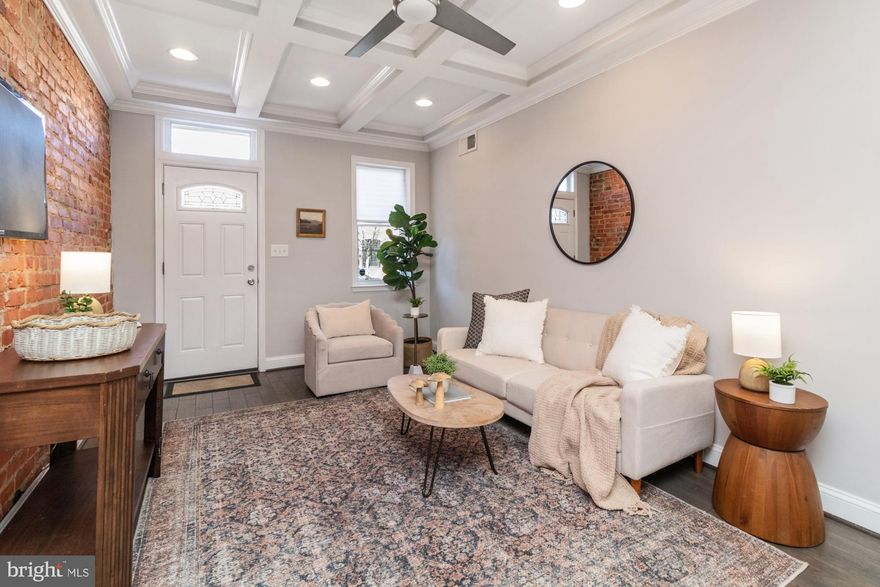13 foot wide row home now available on an extremely sought-after block in Canton. Parking pad out back & 2 tiered rooftop deck. Brand new carpet and fresh paint. Glistening hardwoods cascade throughout with tons of natural light. Enjoy your coffered ceilings, exposed brick and half bath on the main floor. In the designer chef's kitchen you will find high end white cabinetry, upgraded trim and paint, imported tile, granite countertops, and upgraded stainless steel appliances. Off the kitchen there is a designated entrance for the parking pad. Upstairs you'll find two bedrooms, and a large hall bathroom with a double vanity. Off the rear bedroom you will access the two tiered rooftop deck with amazing views of the Baltimore City Skyline and the Inner Harbor. The finished lower level with high ceilings includes an additional bedroom, living space, full bathroom and laundry and storage area. Major whole house renovation completed in 2017. Close proximity to retail shopping, local dining, Patterson Park and all major highways. Schedule a private tour today.