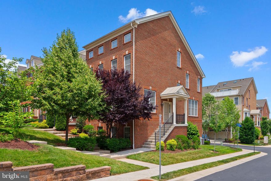 Fabulous Brick Front End-Unit Townhome – "EASTON" Model with Loft & Rooftop Terrace! Pool and extra parking around the corner. This stunning 4-level end-unit townhome features the highly sought-after Easton model with a top-level loft and a private rooftop terrace—perfect for relaxing or entertaining. Step into a spacious and stylish gourmet kitchen outfitted with rich Cumberland Maple Espresso cabinets, Bianco Antico granite countertops with a beveled-edge tile backsplash, and stainless steel appliances, including a wine fridge and deep stainless sink. The open-concept layout includes a bright breakfast area and a large family room with a cozy gas fireplace and custom mantle, plus access to a second outdoor deck right off the kitchen. The elegant sunken foyer flows into a spacious living room and formal dining area, offering the perfect space for gatherings. A turned staircase leads to the luxurious primary suite, complete with vaulted ceilings, an oversized walk-in closet, and a spa-like en-suite bath featuring a soaking tub, dual-sink vanity, private water closet, and custom tile flooring. Unbeatable location—walk to Arundel Mills Mall, Maryland LIVE! Casino, restaurants, coffee shops, and the community pool. Commuter-friendly with easy access to Route 100, 295, Ft. Meade/NSA, BWI Airport, and the MARC Train.    https://youtu.be/3yi5NSkkrOs