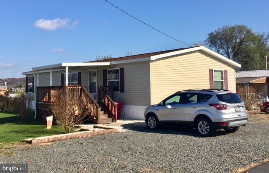 Back on the market!  This manufactured home is on a huge lot and has 5 parking spaces.  Immaculate inside and out, 3 BRs... or 2BRs plus a den. Large kitchen, a whole lot of counter top!, garbage disposal, flat-top elec. range, and the kitchen is very spacious and bright.  Lots of pantry space: pantry closet plus an additional large walk-in pantry.  Laundry adjoins kitchen. MBR is spacious, with a double closet, vaulted ceiling.  Huge master bath, large shower, French doors, linen closet.  Main bath is on other side of the home, off the hall, w/tub & shower, and it is as clean as a whistle.  View of sunset from front porch/deck.  First floor laundry, door to outside & rear yard, and there's a great shed out there.  The den/office/BR can be a cozy retreat but is close to main living area.  Can serve as guest bedroom, computer room, TV room/den.  This home is spotless, so well-maintained, and it is bright and cheery everywhere.  A 1-year home warranty is being offered. Lot rent includes water and sewer, snow removal, trash collection, maint. of common areas.