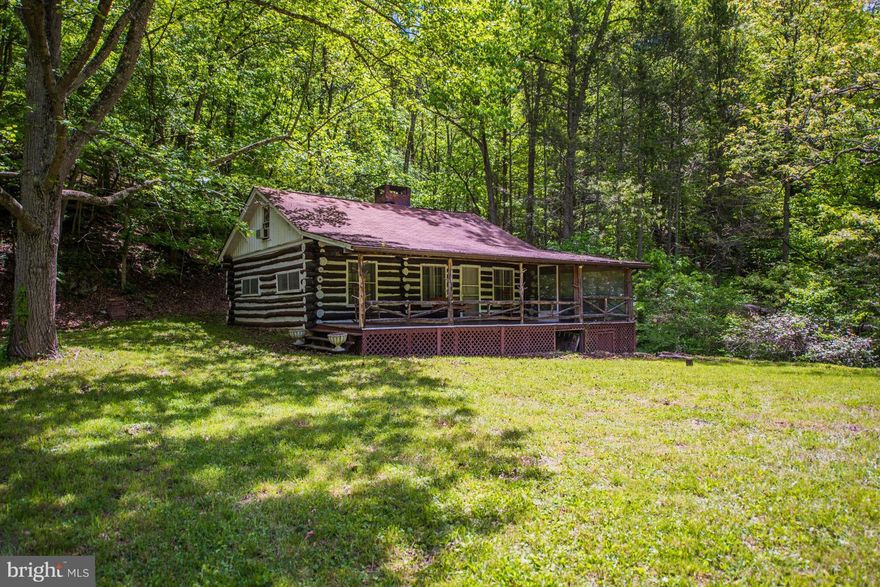 River Front Log Cabin, this is the real deal built in 1937 using local logs and stone, has stood proudly on the rivers edge for over 80 years. 7.64 acres, nearly 690' ft of creek frontage, 2 bdr, a huge upper bunk room. Stone fireplace, wood stove, wrap around screen porch with a year long stream running underneath, set up for peaceful evening dinning. If you're a river lover, this ones for you!