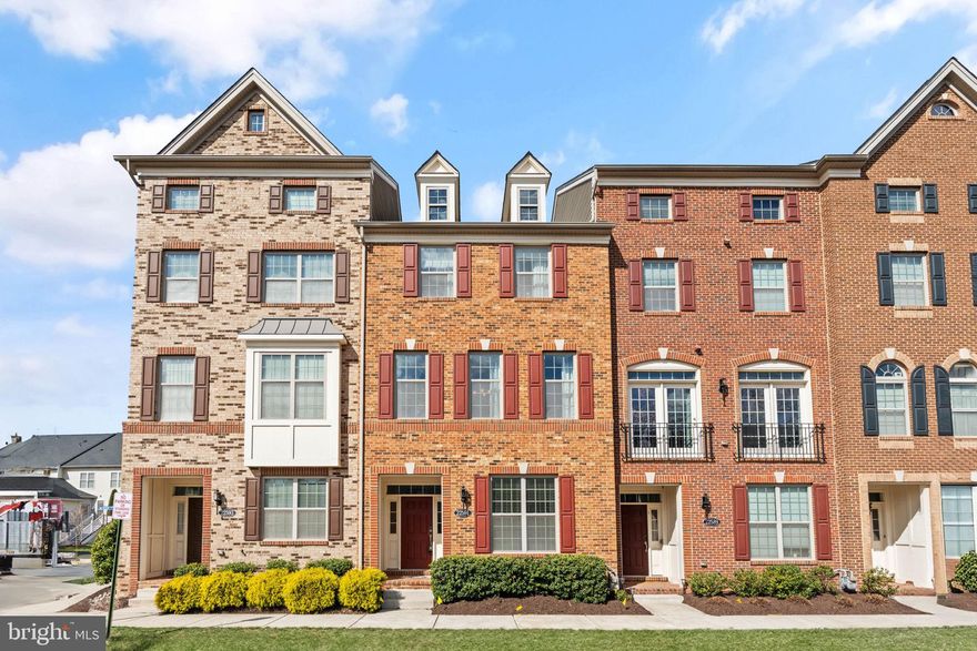 Welcome home to popular Moorefield Station! Located in the heart of Ashburn, this gorgeous townhome boasts an open and thoughtfully designed floorplan with abundant natural light and modern elegant finishes on all three levels! On the main level of the home, discover a spacious living room with elegant crown molding, a sophisticated ceiling fan, and floor-to-ceiling windows filling the space with natural light. Gleaming hardwood floors flow seamlessly into the stunning kitchen, featuring rich wooden cabinets, sleek granite countertops, and stainless steel appliances including a wall oven and microwave. Pull up a stool to the oversized island bar for a casual meal, or move to the light-filled dining room to host a family celebration or dinner party. With this show-stopping kitchen in the center of the home, this floorplan is truly ideal for entertaining. Upstairs you’ll find the luxurious primary bedroom suite, boasting a stunning tray ceiling and massive walk-in closet with a custom closet system (that includes a lifetime transferable warranty). The en suite bathroom is modern and pristine, featuring a wide double sink vanity and step-in shower with built-in seat. Both additional bedrooms on this level include high ceilings and wide closets with their own closet systems, and share access to the second full bathroom in the hallway. Convenient bedroom-level laundry rounds out this floor of the home. Downstairs on the lower level you’ll find a rare entry-level bedroom with a handsome attached bathroom, a perfect quiet spot for guests or a home office. On the back of the home, step out onto your private Trex deck to sip your morning coffee or enjoy outdoor dining! The two-car garage with overhead racks gives you plenty of space for both parking and storage. Water softener conveys. Community amenities include an outdoor pool, on-site fitness center, club house, professional landscaping, pet stations, and visitor parking. Close to everything you need! Just minutes to Harris Teeter, Brambleton Town Center, Loudoun Station, Regal Cinemas, Dulles Landing, Lyndora Park, Dulles South Recreation Center, StoneSprings Hospital Center, and Dulles Airport. Quick access to the Ashburn Metro Station, Loudoun County Parkway, Dulles Toll Road, Route 50, Route 28, and Fairfax County Parkway for ease of travel around Northern Virginia. Sellers request rent-back through the end of May. Schedule a private tour of your gorgeous new home today!