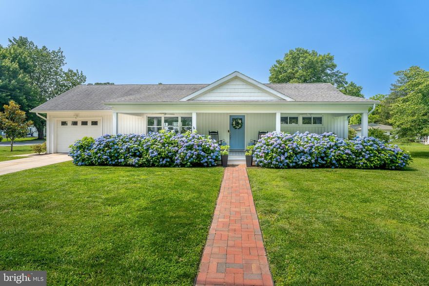 Welcome to one of Berlin's most charming and versatile homes, owned and thoughtfully redesigned by a proud local resident with a deep appreciation for the town's character and charm. Perfectly positioned on a spacious double corner lot, this picturesque property is just a short walk to Downtown Berlin and all that "America's Coolest Small Town" has to offer. Located directly across from Buckingham Elementary, this lovingly maintained ranch-style home offers one-level living with an unexpected bonus: a large one-bedroom in-law suite complete with a fully equipped kitchen and private full bath. Whether you're envisioning multi-generational living, a private guest suite, or potential rental income, this flexible space offers endless possibilities! Inside the main home, you'll find three comfortable bedrooms and two beautifully updated bathrooms. The large primary ensuite bathroom features a double vanity and double walk-in shower. This home's open floor plan and modern kitchen create a welcoming space that's perfect for everyday living and entertaining. The updated kitchen boasts stainless steel appliances, a gas range with specialty hood vent, and a layout that balances form and function. Whether you're preparing weeknight meals or hosting weekend gatherings, this space rises to every occasion. Other noteworthy upgrades include bamboo flooring throughout, crown molding in the main living space, Nest thermostat, updated roof, updated windows, and fresh paint. Step outside to enjoy your fenced-in backyard oasis featuring a large back deck and a huge yard with plenty of room to play or unwind. But the real showstopper? The expansive front porch, designed to mirror the iconic front porch of Berlin's historic Atlantic Hotel. Framed by lush hydrangeas and exuding pure small town charm, this is the kind of porch where memories are made, meals are shared, and neighbors become friends. Enjoy easy walkability to all of the boutiques, restaurants, and vibrant town events that give Berlin its small town magic. A unique property like this, steeped in community, comfort, and character, is a rare find. Schedule your tour today and see why this special place is one you won't want to miss!