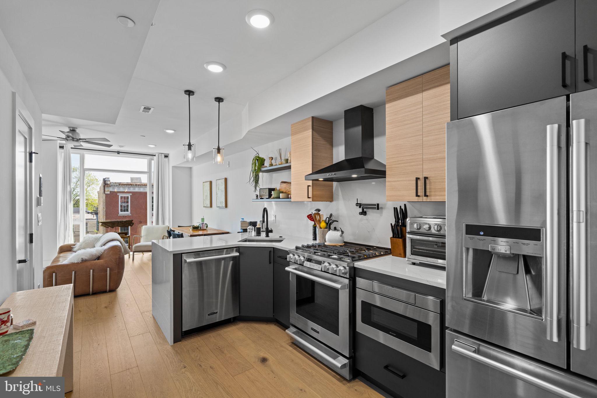 Rarely offered in Graduate Hospital is a bi-level unit that is tastefully designed and bright with DEEDED PARKING, PRIVATE ROOF SPACE and the majority of time remaining on the FULL ABATEMENT (approximately 8 years)! Stepping inside, the tasteful design and style is immediately felt. With an open floor plan, incredible floor to ceiling windows, a statement fireplace and wide plank white oak flooring every detail was clearly accounted for. The extremely functional kitchen features designer modern soft close cabinetry, sleek veined white quartz countertops and backsplash and an upgrades Chef’s grade appliance package. Upstairs, the unit continues with two spacious bedrooms each showcasing over sized walk-in closets with custom built-ins and accent walls. The gorgeous primary bath has designer tile, double sinks and an oversized glass shower with rain shower head. A guest bathroom and stacked laundry complete this floor. Finally, the private roof deck with views of the Center City Skyline finishes off the highest level of the home. Walking distance from Center City, Rittenhouse Square and the Schuylkill River Park/Trail there is no better place in the city to call home. Low condo fees, the majority of the full tax abatement, a private roof deck and deeded parking make this unit the one not to miss! Make an appointment today!