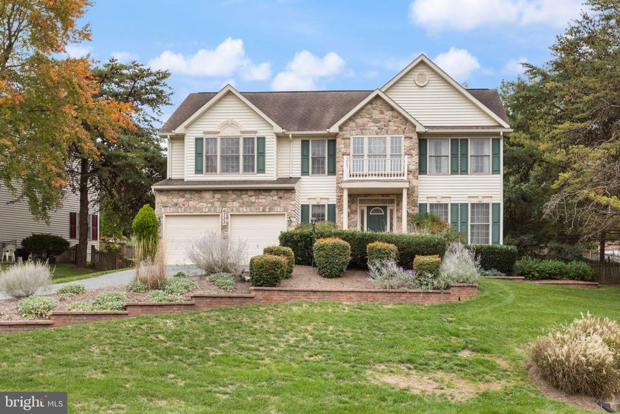 Welcome to this exquisite property that offers everything you’ve been looking for in the heart of Woodridge! This home welcomes you with extensive hardscaping and stone work in the front and the kitchen features high-end custom cabinetry and plenty of counterspace and walks out to one of the most enticing features of this property, the spacious rear deck. This outdoor space overlooks the fenced rear yard and even more extensive hardscaping to maximize the use of the backyard.  Also offers family room off the kitchen with wood burning fireplace and transom windows, separate dining room, grand master suite featuring an ensuite bathroom with separate shower/garden tub, huge walk in closet and cathedral ceilings.  The dual access bath serves the rest of the spacious bedrooms upstairs.  The lower level of the house is a walkout level basement, which is versatile and can serve various purposes, such as a recreation room, a home gym, or additional living space.