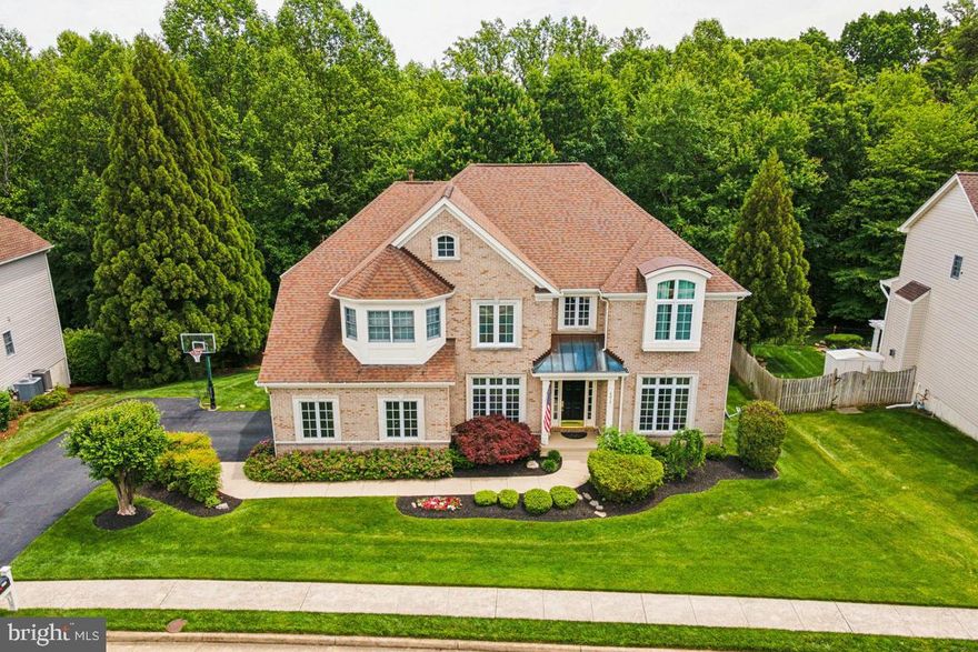 Enhance your living experience with this exquisite property nestled in the highly coveted Preserves of Wynmar! This wonderful Edgemoore Homes Huntington II model features 4 bedrooms, 4.5 bathrooms, 2 car side load garage, over 5100 finished square feet and backs to the 650 acre Ellanor C Lawrence Park. Enjoy cooking your gourmet meals in this remodeled and updated gourmet chef's kitchen featuring custom cabinetry, butlers pantry with built-in wine rack, granite countertops, stainless steel appliances, center island and breakfast room! Situated off of the kitchen is a wonderful 2 story family room with a gas fireplace with a travertine accent wall. Complementing the main level is a formal dining room with coffered ceiling, crown and chair moldings, a large living room, great home office, half bathroom and laundry room. 

Ascend to the upper level to discover an indulgent primary owner's suite featuring a sitting room, tray ceiling, walk-in custom closets, an amazing remodeled luxury primary owners bathroom with a large double vanity, spa-like soaking tub, an oversized shower, heated floors and marble & tile flooring. Completing the upper level are 3 spacious bedrooms with all new upgraded carpet and padding, 2 additional remodeled bathrooms and hardwood floors in the hallway. 

Venture downstairs to the fully finished walk-out basement with an enormous rec room, a great wet bar with 3 additional refrigerators, a theatre room with reclining seating, projector, screen & equipment, a cozy sitting room with custom built-ins or easily converted to a 5th bedroom, full bathroom and storage room. Enjoy entertaining, then you will love the composite deck with built-in grill and custom stone and brick patio with hot tub! Additional property updates and features include new roof in 2018, HVAC systems in 2012 & 2019, water heater in 2017, new upgraded carpet and padding in the bedrooms, hardwood floors and so much more! 

This home has been meticulously maintained and updated by the original owner. Fantastic location within minutes to Rt. 50, Rt. 28, Rt. 66 & Dulles Airport!  The surrounding area offers walking trails, the newly constructed Woodlands Stewardship Nature Education Center, the Chantilly Wegmans, great restaurants and shopping and a great school district. Schedule a showing today and experience unparalleled luxury living!