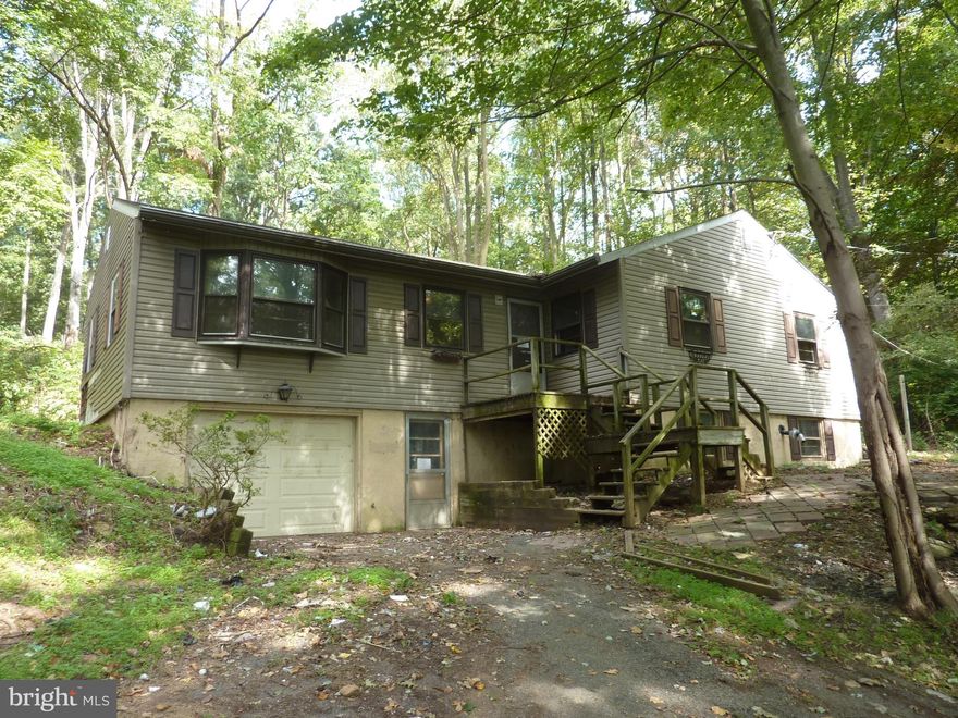 Raised Rancher on a secluded heavily wooded 1.8 acre lot. Tons of potential, but it needs  a total rehab from top to bottom. Basement has mold, HVAC is not functional, plumbing is not funtional, entire interior need to be redone, but it could be nice when it's done. Financing must be cash or rehab loan. Freddie Mac First Look Initiative owner occupied buyers only through October 13, 2019.