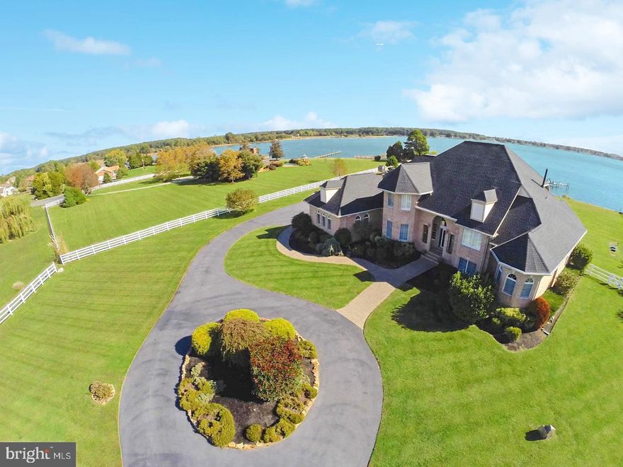 Discover the epitome of waterfront living with this 7-bedroom custom-built gem nestled on the shores of the Eastern Bay. This unique offering is beautifully sprawled over 2.4 acres of prime waterfront paradise, boasting 300'+ of private shoreline, a BRAND NEW dock with 3 lifts, and your very own sandy beach to enter the Bay. You will not find another property with these attributes in the Stevensville or surrounding areas. 
As you drive through the gates onto the circular driveway, and past the green grass, trees, and fully-fenced in yard,  there awaits the beach house.   You're greeted by an open floor plan that perfectly marries luxury and comfort. The main level is graced by a splendid master suite adorned with a cozy fireplace and opulent bath, a modern and fully-equipped kitchen, a spacious great room featuring a stone fireplace, and French doors that guide you to a wrap around deck and fenced yard. Downstairs, you'll find a dry lower level fitted with a second kitchen and abundant storage and living areas, ensuring every inch of space is put to good use. Upstairs, you find 3 spacious bedrooms, 2 Full baths, and 2 balconies that face the Chesapeake Bay.  The home was custom built in 2000 with a brand-new roof and home generator added in 2014, reflecting the meticulous upkeep of the property. The exterior is just as impressive, with immaculate landscaping, a circular driveway, a side load two-car garage, and a large fenced rear yard offering captivating views of the pier and beach. Situated on a private cul-de-sac on Kent Island, the property is a stone's throw away from the Bay Bridge, Annapolis, Baltimore, and Washington. The location, coupled with its potential as a BNB or VRBO (similar properties garner over $1,000 per night in peak season), makes this an opportunity too good to miss. Bask in the glory of coastal living like never before.