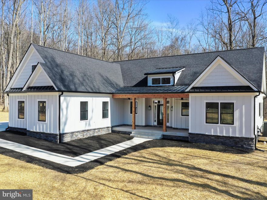 This stunning custom-built home offers the perfect blend of luxury, comfort, and convenience, all nestled on 2.55 acres of private, picturesque land. Located in an exclusive gated community with river access and a boat marina and only 15 minutes to shopping, restaurants and the interstate. This 4-bedroom, 3.5-bath home showcases impeccable craftsmanship and thoughtful upgrades throughout.
As you approach the property, you'll immediately appreciate the upgraded siding and exterior trim, the oversized front porch, and the carefully installed oversized gutters and downspouts. Step onto the covered back porch to unwind by the gas fireplace and take in the serene surroundings, where deer often wander through the backyard.
The oversized 2-car garage is heated and equipped with hot and cold water, plus an EV charging station for your electric vehicle. As you enter through the front door, you’re welcomed by a grand foyer, setting the tone for the elegance that lies within. The two-story stone double-sided fireplace is a stunning focal point of the living area, adding warmth and character.
The gourmet kitchen is a chef’s dream, featuring a butler’s pantry, gas range, double ovens, convection microwave, and a beverage refrigerator, all complemented by 9-foot ceilings throughout. Enjoy upgraded flooring, including heated floors in the luxurious primary bath, where you can soak in the oversized soaking tub for ultimate relaxation. The primary suite also includes a large walk-in closet with custom built-ins for added convenience.
The laundry room is equipped with ample custom cabinetry, and the home offers a Jack and Jill bedroom and bath, perfect for children or guests. Upstairs, an oak staircase leads to a second bedroom suite complete with its own full bath, walk-in closet, and dedicated heating and cooling system.
No detail was overlooked in the design of this home, from insulated soundproof interior walls to all solid interior doors. There is a 300-square-foot finished storage area, providing even more space for your needs. Whether you're entertaining or enjoying a quiet evening, this home offers everything you could want and more.
This is truly a rare opportunity to own a piece of paradise in one of the most sought-after communities. Schedule your showing today!