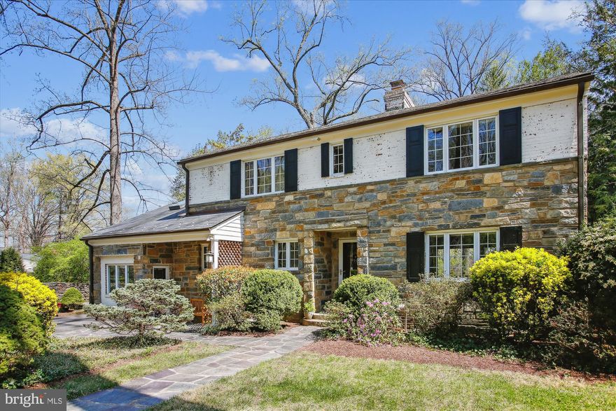 Welcome to 3825 Birchwood Road. Situated on a spectacular 15,064-square-foot lot with gorgeous mature trees, this stone and brick home is truly enchanting. Originally built in 1948, this farmhouse-style residence has been expanded and updated over the years, incorporating numerous aesthetic improvements, including a charming, attached apartment. Nestled in a bucolic setting, this property showcases extraordinary architectural details such as original woodwork and floors, beautiful replacement windows, rich wood trim, and exceptional outdoor spaces. This magnificent home exudes charm—you’ll be delighted at every turn!
Enter the home through a covered entryway. To the right, a generous living room features recessed lighting and a marble-surround fireplace. The open dining room boasts chair rail molding and provides access to the deck through sliding glass doors. The renovated kitchen includes GE stainless steel appliances, beautiful wood cabinetry, gas cooking, granite counters, and a delightful breakfast room with tile flooring, an exposed brick wall, and access to the spectacular gabled screened-in porch. The main level is complete with a powder room and a coat closet.
Upstairs, you will find three bright bedrooms with wood flooring and two updated full bathrooms, including the spacious primary bedroom suite. The suite features a wall of closets, a sitting area, amazing tree-top views, and a private bath. The renovated primary bathroom boasts a floating double vanity with vessel sinks, a tub/shower with a glass barn door, and a recessed niche with chevron accent tiles.
Downstairs, a striking family room has four large, square windows spanning two levels, offering expansive backyard views and flooding the space with natural light. The unique design of this room allows the living room to overlook a section of the family room, creating an area with soaring two-story ceilings. This sun-drenched family room also includes a wall of display shelving, a magnificent gas stone fireplace, and a sauna. Off the family room is a large storage/laundry room with a cedar closet, a utility closet, and backyard access. This level also features a workroom for added convenience. 
The attached two-story apartment is ideal as a guest space or in-law suite. It has its own separate entrance, a living area, a mini kitchen, and a full bathroom on the main level. Upstairs, there is a bedroom with a closet and a skylight. 
The lushly landscaped property includes an extensive driveway, magnificent stone hardscaping, stone pathways, a screened-in porch perfect for outdoor dining or entertaining, a deck, a brick patio, and a large shed. The yard is adorned with gorgeous mature trees, hostas, hydrangeas, lilies of the valley, azaleas, and a deep fenced backyard.
Ideally located near Harris Teeter, Trader Joe’s, and the shopping centers of Bailey’s Crossroads, with easy access to Route 7, Columbia Pike, I-395, and I-495.