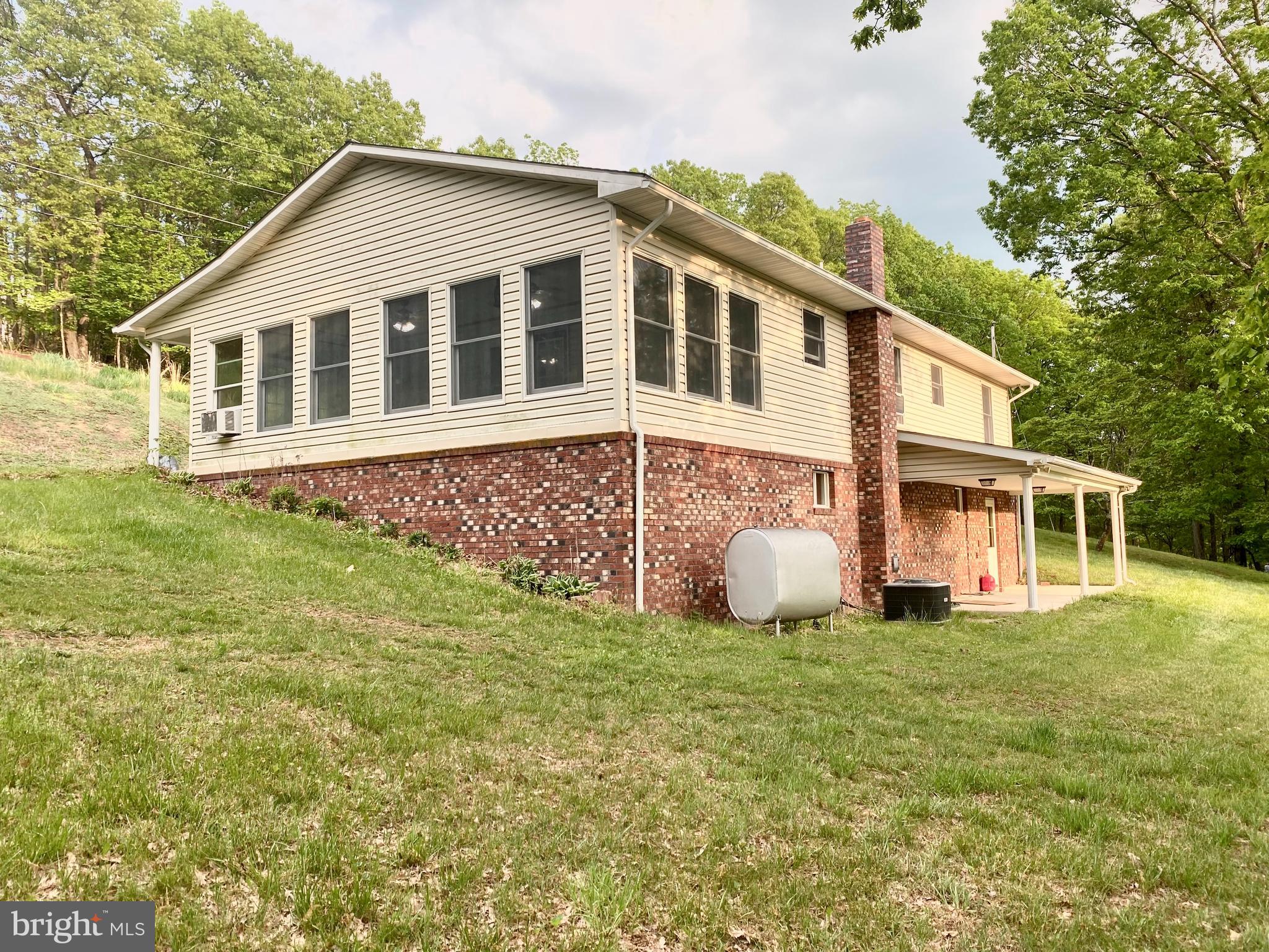 Quiet home in the highly sought after Serenity Heights community. This 3 BR 2 Bath sits on 2 acres of land with a beautiful view of the mountains. A full finished basement equipped with a full bathroom provides endless possibilities. The huge detached two car garage adds a ton of additional storage or would be perfect for a workshop. Choose your heating source! Home is capable of using wood, coal, oil, or electric heat. Main floor is ready for some TLC to make it your own!