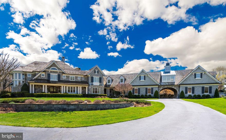 This one-of-a-kind offering custom built by award-winning BOWA is perfectly sited on 5 gorgeous acres and is located within the rolling hills of close-in Great Falls.  Design meets extraordinary comfort in this expansive turn-key custom home spanning over 14,000 square feet  with 7 bedrooms, affording the ultimate private resort-like living. Meticulous attention to detail was employed to build the finest American Shingle style residence blending traditional elements with modern luxuries, and complemented by the quality craftsmanship of BOWA Builders. Pristine landscape architecture and lush gardens ensure privacy while integrating the property s great vision with its natural environment in the most beautiful way. Indoor-outdoor entertaining is seamless with grand but gracious rooms that open to stunning exterior spaces. Indulge in the integrated design of a heated pool with spa and waterfalls, covered flagstone pool terrace with outdoor fireplace, putting green, and outdoor kitchen, providing an unparalleled outdoor experience. Also nestled on the grounds is the original but updated guest house and a spacious 5-car garage, divided by a porte-cochere. One of the garages has been outfitted as a heated indoor basketball court. An awe-inspiring interior is introduced by a dramatic entry foyer and formal living room. Exquisite details and architectural elements are at every turn, among them the finest woods, included a mahogany paneled library with coffered ceiling. Security cameras, state-of-the-art appliances, automated Lutron lighting system and built-in speakers enhance the property. Two stair cases connect to all floors. Walls of windows invite an inpouring of natural light, epitomized in the spectacular 2-story great room with soaring ceiling and roof-level windows. The distinct yet understated elegance continues in the formal dining room, fabulous gourmet kitchen with handmade custom cabinetry,  large walk-through pantry, butler s pantry and glass-enclosed temperature-controlled wine cellar with stunning stained glass feature, generous pantry, hearth room with floor-ceiling stone FP, multiple French doors to exterior. A side service foyer, garage-entry mud room, catering kitchen, office/homework room, pool powder room, and bonus laundry complete the main level. Comprising the 2nd floor are 6 separate bedroom suites with ensuite bathrooms and walk-in closets, a separate walk-in cedar linen closet, and a 2nd laundry. 2 of the secondary bedrooms have vaulted ceilings, and 4 have entry vestibules. The master suite is its own paradise with a sitting room, vaulted ceiling in the bedroom with a marble two-sided fireplace, custom closets, and incredible spa bath.The finished lower level retreat presents large living and family rooms, a fully outfitted bar,  billiards room with floor to ceiling stone wall, Fire place, French doors walk-out to flagstone patio, game, exercise, theatre and recreation rooms, a walk-out garden court, guest bedroom suite with walk-in closet and full bath, 2 powder rooms and large storage area.The Garage also offers stairs to a generously-sized unfinished space on the second level for optional au-pair suite and rough-in for full bath.