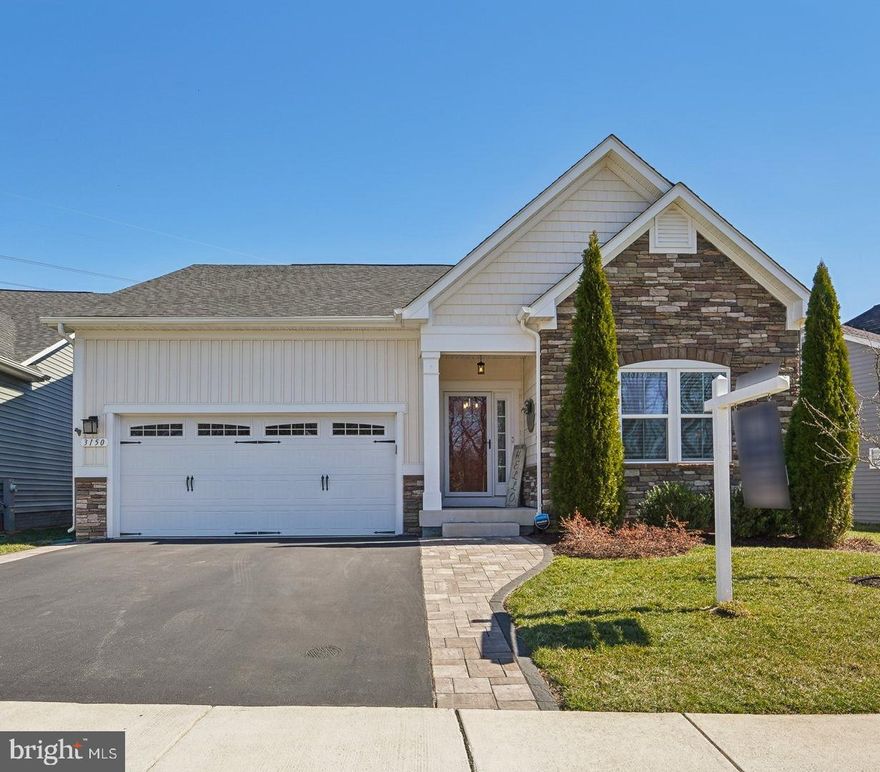 Get ready to embrace this lifestyle in this inviting home and community. The Sanctuary at Two Rivers and this three- or two-bedroom home with an office and three full baths was built with an optional extended Kitchen and dining area. The extra square footage is not reflected in the tax records. The modern kitchen with a large island, gas cooktop, wall ovens, and additional cabinet space (due to the extended floor plan) is open to the living room with an upgraded stone fireplace. There are hardwood floors throughout the main level. Retreat to the mostly finished lower level and enjoy the shiplap wall featuring an oversized wet bar with two beverage refrigerators and cabinet space. There is also a full bath on this level. There is a double-door walk up to a newly created private oasis. The outdoor living space includes a composite deck with a sunk-in Hot tub, dining, and lounging areas. The paver patio area backs to trees and is beautifully landscaped. This 55+ active community offers wonderful amenities, including indoor and outdoor pools, pickleball and tennis courts, and wonderful meeting spaces within the clubhouse. There are events and activities for all interests.