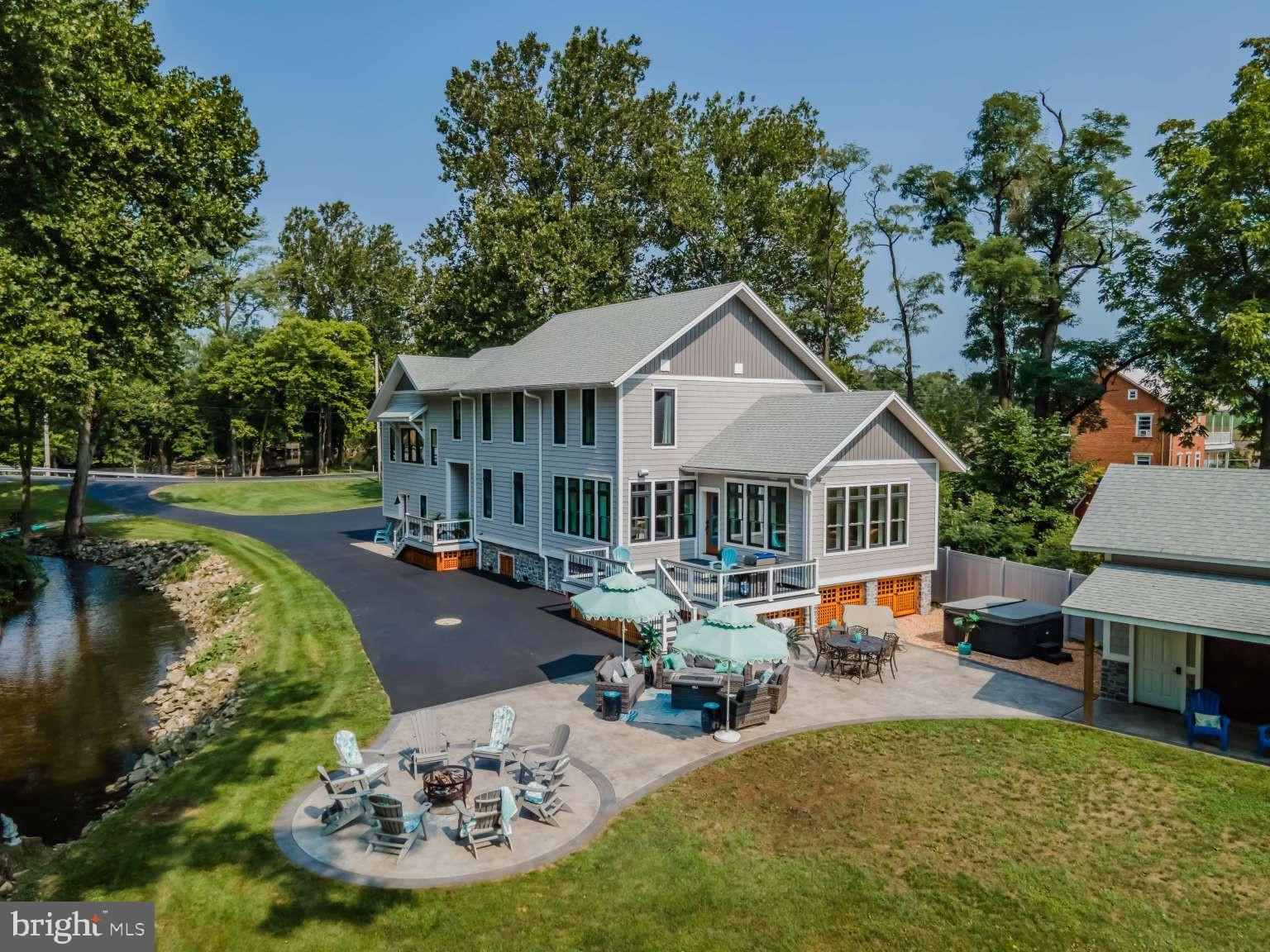 UPDATE: New sewage system being designed/installed for 5 bedrooms, allowing new owners to convert extra rooms to 4-5 bedrooms and extremely low-cost flood insurance cost, if required. Be prepared to fall in love with this 21.9 acre waterfront home currently with 3-4 bedrooms, 2.5 baths on the scenic Yellow Breeches in Cumberland Valley School District. This property consists of 2 parcels. Watch the amazing videos! This charming creekside property is a rare opportunity to live on 1,200 LF of picturesque private tributary with an island bordered by the Class A trout stream. Wildlife lovers will enjoy the abundance of deer, blue herons and ducks that make this preserve their habitat. Fisherman need only walk out the front door and cast a line. Paddlers will enjoy kayaking the Breeches and gliding right into your own yard. And there’s plenty of room for motorsport enthusiast’s atvs and dirtbikes to trail around. With a nod to the handsome beach homes of the eastern shores this retreat won’t disappoint. It is beautifully designed in a relaxed coastal-farmhouse style with shiplap walls, cherry cabinets, luxury Cambria quartz countertops, marble tile bathroom, and 7” white oak plank flooring. With 4,000 SF of living space this home offers two exceptional areas that can be used for an office, playroom, fitness room, media room or crafting space. Use your imagination! Energy conservationists will love the super energy efficient design that keeps both cooling and heating bills very low. Also, loads of storage space from the conditioned attics to the accessible crawlspaces and in between. Situated on the old Leidigh Mill with water on two sides of the house, enjoy the water view from the front and the trickling sounds from the open windows on the mill side. This haven is less than 15 minutes to downtown Carlisle, Mechanicsburg and Dillsburg and only 8 minutes to Interstate 81 and Route 15. There are many more features to learn about in this 2020 rebuilt estate. Don't wait to tour this rare, custom waterfront property before it's gone!