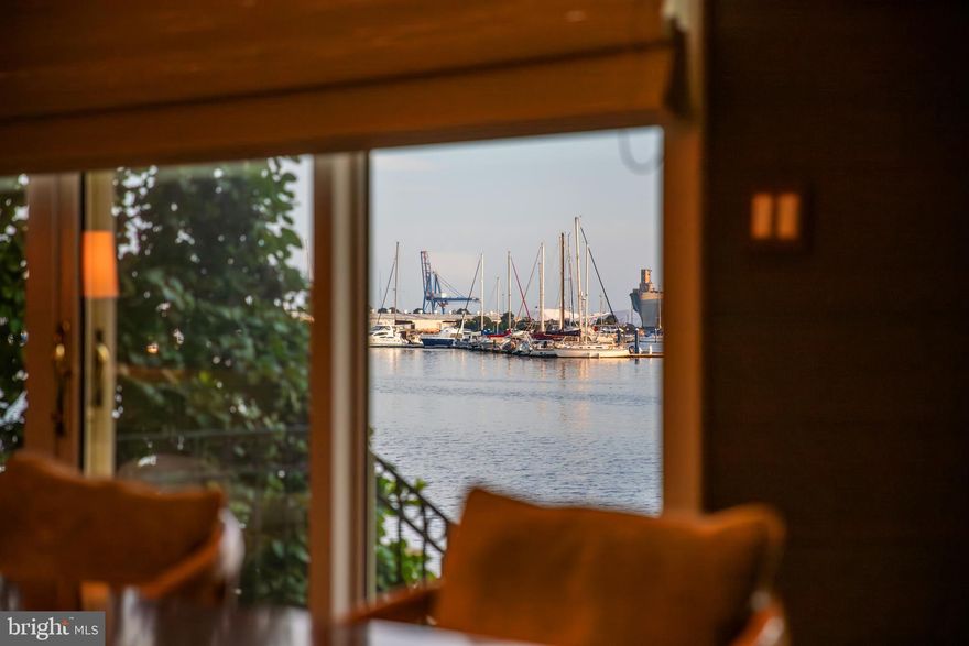 Live authentically. If you’re looking for one-of-a-kind waterfront, this is it. The only fully custom home in desirable North Shore. Purchased directly from the developer during framing and fully reimagined with a totally unique floor plan and top of the line materials. Step inside and instantly fall in love. Stunning custom walnut staircase greets you as you enter. A few more steps and your eyes will be wowed by the expansive views of sparkling water. Spacious ground-level en-suite bedroom with custom built-ins is flanked with a wall of glass that stretches the entire width of house and walks directly out to the promenade. Step upstairs to a sophisticated space anchored with intentional design. This main level offers a unique layout with the perfect blend of defined spaces and seamless flow. Designed to live like a true home, this middle floor offers two living and dining spaces, both formal and casual, two fireplaces, a powder room and three walls of glass. 
The glistening 7” wide walnut plank floors are unlike anything you’ve seen in North Shore and are the perfect compliment to the custom crisp white plantation shutters and window treatments throughout home. Gorgeous eat-in kitchen with top of the line appliances and an elevated casual dining nook with the very best view. Step up one more level to a peaceful third floor reminiscent of a boutique hotel. Two gorgeous en-suite bedrooms and spacious laundry room. The primary is flooded in natural light with a balcony overlooking an unmatched view of the water. As one of only 12 houses on the Baltimore waterfront with breathtaking open water views that will never be developed, you can rest assured that what you see is what you get, forever. This home is incredibly maintained from top to bottom with all new Marvin Ultimate sliders and windows recently installed on the water side of property. Cultivate your existence. The art of uniting human and home.