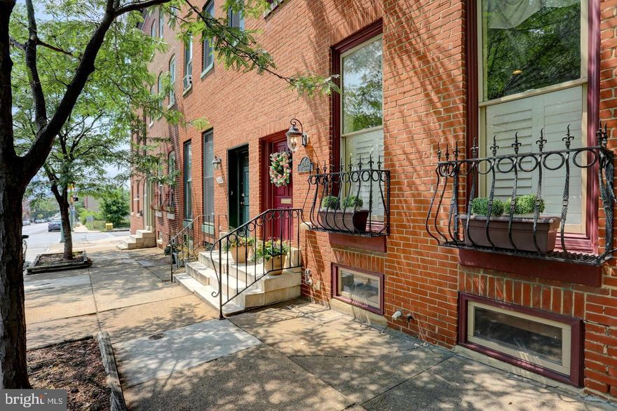 A perfect blend of Victorian elegance and modern convenience, spanning over 3,000 square feet, this meticulously renovated townhome offers 3 bedrooms, 2 full & 2 half baths, and a dedicated parking pad. 

This beautiful residence welcomes you with gleaming oak floors, hand-wrought ornamental ironwork, artistic murals, four fireplaces, and thoughtful design details. Designed for both everyday living and entertaining, the main level maintains a traditional layout while offering an open sightline for seamless connectivity and a flood of natural light. The chef’s kitchen features professional-grade stainless steel Jenn-Air stove, wood cabinetry with dovetail drawers, granite countertops, and stainless steel appliances. 

Outdoor spaces are just as impressive. The ground floor includes a concrete patio with wrought iron fencing plus a custom gate that secures the courtyard. A wrought-iron Romeo and Juliet balcony adjoins a charming bedroom, while the third-floor primary suite boasts its own private multi-level deck with panoramic views of the city skyline and Johns Hopkins Medical Campus. Storage is plentiful, with multiple walk-in closets and a lower-level basement for additional space. Dual-zone heating and cooling ensure year-round comfort.

Become part of the vibrant & historic Butchers Hill community. Live two blocks from Johns Hopkins Hospital and minutes from Fells Point, Canton, Harbor East, and all the amenities of downtown while being cradled by the best backyard in Baltimore, Patterson Park, spanning 137 acres and a hub for recreation, history, and community gatherings.