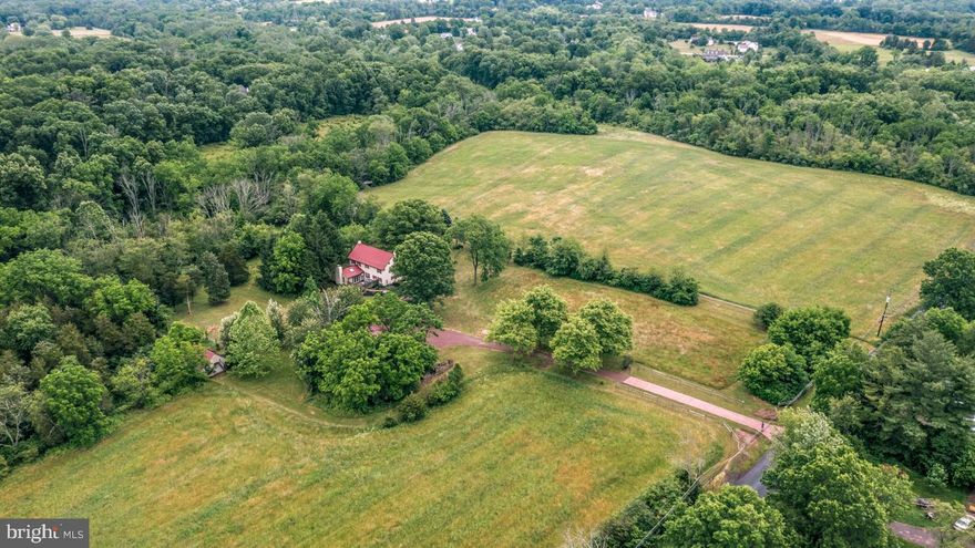 NEW OPPORTUNITY!  Nowhere else will you find an idyllic farm estate with 33 acres of pristine land, which also adjoins Evansburg Park with 3,000 + acres of natural preserve.  And, the property is zoned R-1A and can be subdivided.  I

Accompanied by a separate three-car garage and loafing/run-in shed, (including storage) the spacious 1799 stone farm home in sought-after idyllic Lower Salford Township with  33 acres can accomodate  livestock, horses, sheep, goats, etc.   and has  a sparkling stream to be enjoyed by residents and their animals.

 A flora bordered brick walk leads to the main house and 1,000 sq. ft. partially covered outdoor porch which  overlooks grape arbor and trickling pond.  Visitors are captivated by the flowing floor plan.  The kitchen is highlighted with SS appliances and back splash, farm sink,, gleaming  stone countertops, and a breakfast area blessed with a view of the property. An exceptionally large dining room is an invitation to host wonderful family dinners and holiday brunches around the fireplace. Guests will enjoy gathering in the sizable family room and adjoining 400 sq ft. great room addition with cathedral ceiling, twinkling skylights and handsome working fireplace.  Two sets of atrium doors - one door leads to a private garden area.

Upstairs, more possibilities await.  The rooms easily adapt to more than just bedrooms.  Home office, media center, library or cozy den are just a few ideas.  The master bath is enhanced by a Jacuzzi tub and attractive fixtures.

Among other numerous pluses of this 1799 farm home filled with charm and character are original wide plank hardwood floors, deep sill window, original barn beams accenting the Family/Great Room and newer tin roof.  Stone walls , new  2 zoned heating system and new tankless hot water heater are economical assets, coupled with the fireplaces that warm the home, often eliminating a need to raise the thermostat.  In addition,, brand  new heating system has just been installed.

In all of its seclusion  surrounded by  natural wildlife, this perfect farm  property is  within walking or biking distance to  SKIPPACK VILLAGE with 19 restaurants, shops, art galleries, spa, wine tasting, holiday parades and ALL THE FUN !   Evansburg Park is next door with over 3,000 + acres of natural preserve, walking trails, and open space for hiking, biking, fishing, and water sports.  Minutes to Lederach Golf course, Skippack and Mainland golf courses. Only 10 minutes to Rte 422 and Providence Town Center with Wegman's, Movie Tavern and 50 retail stores.  5 Minutes to PA Turnpike. 

Subdivision is possible as the property is zoned R-1A which zoning should allow for 80,000 sq. ft lots!
This would be the  ultimate location  and situation for a family compund!

Currently under Act 319 which provides big savings per year in RE taxes

 Call for more details and specifics on this one-of-a-kind  farm property with 33 acres.
If you missed out - TIMING IS EVERYTHING - You can still own this irreplacable 
magnificent piece of paradise - Priced to Sell!