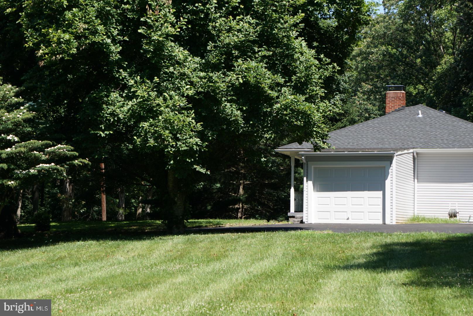 A Home and Landowner’s Dream! Relax and unwind in your 2021 new fully renovated home (inside and out including HVAC) on over 1 acre of land located at the end of a quite, dead end street. Enter your main level to a cozy living room with a built-in electric fireplace and breathtaking decorative ceiling design. Enjoy 3 completely renovated bedrooms with remote controlled fans, 3 bathrooms (main has allen + roth Moravia 60-in White Undermount Double Sink Bathroom Vanity with Natural Carrara Marble) with unique design, brand-new flooring, and crown molded ceilings throughout. Savor mealtime in your fully renovated kitchen with state-of- the-art stainless steel appliances (Air Fry Smart Wi-Fi Enabled 30-in Smooth Surface 5 Elements stove and Quadwash dishwasher), granite countertops, decorative backsplash, and recessed lighting throughout. Enjoy the newly renovated outdoor stamped concrete patio area off the kitchen to retreat from the heat and enjoy your cool summer beverages. This charming home offers plenty of finished living space on the lower level! Make this space your own by converting it to a family recreational area or into a luxurious home office. This cozy lower level includes a fireplace, full bathroom, beautifully renovated flooring, and an oversized laundry room with plenty of storage space! Make this your home and take advantage of the endless possibilities for future addition(s). Multi generational living is definitely an option. This beautiful, fully renovated home located on a quite dead-end street, offers plenty of space for cars and storage! Newly built garage and brand new asphalt paved driveway offers 6 parking spaces. Surrounded by cleared off conservational green space, you will find this home private, secluded, and serene- yet close to all that Howard County has to offer! Top Howard County Schools. No HOA fees.