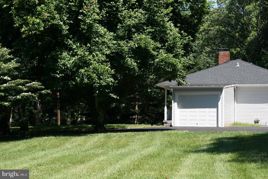 A Home and Landowner’s Dream! Relax and unwind in your 2021 new fully renovated home (inside and out including HVAC) on over 1 acre of land  located at the end of a quite, dead end street. Enter your main level to a cozy living room with a built-in electric fireplace and breathtaking decorative ceiling design. Enjoy 3 completely renovated bedrooms with remote controlled fans, 3 bathrooms (main has allen + roth Moravia 60-in White Undermount Double Sink Bathroom Vanity with Natural Carrara Marble)  with unique design, brand-new flooring, and crown molded ceilings throughout. Savor mealtime in your fully renovated kitchen with state-of- the-art stainless steel appliances (Air Fry Smart Wi-Fi Enabled 30-in Smooth Surface 5 Elements stove and Quadwash dishwasher), granite countertops, decorative backsplash, and recessed lighting throughout. Enjoy the newly renovated outdoor stamped concrete patio area off the kitchen to retreat from the heat and enjoy your cool summer beverages.  This charming home offers plenty of finished living space on the lower level! Make this space your own by converting it to a family recreational area or into a luxurious home office. This cozy lower level includes a fireplace, full bathroom, beautifully renovated flooring, and an oversized laundry room with plenty of storage space! Make this your home and take advantage of the endless possibilities for future addition(s). Multi generational living is definitely an option. This beautiful, fully renovated home located on a quite dead-end street, offers plenty of space for cars and storage! Newly built garage and brand new asphalt paved driveway offers 6 parking spaces.  Surrounded by cleared off conservational green space, you will find this home private, secluded, and serene- yet close to all that Howard County has to offer! Top Howard County Schools.   No HOA fees.